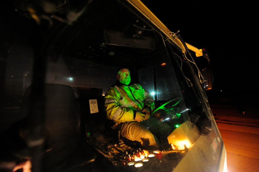 Earnest Midgett, a civilian transient alert mechanic, uses a large aircraft tug to position a C-5M Super Galaxy aircraft assigned to the 436th Airlift Wing at Dover Air Force Base, Del., for refueling Jan. 26, 2013, at Camp Marmal, Afghanistan. The 436th AW conducted the first C-5M multimodal deployment operation in support of U.S. Transportation Command. (U.S. Air Force photo by Tech Sgt. Parker Gyokeres/Released)