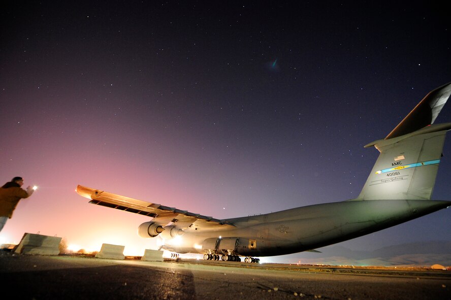 U.S. Airmen push a C-5M Super Galaxy aircraft assigned to the 436th Airlift Wing (AW) at Dover Air Force Base, Del., into position for refueling Jan. 26, 2013, at Camp Marmal, Afghanistan. The 436th AW conducted the first C-5M multimodal deployment operation in support of U.S. Transportation Command. (U.S. Air Force photo by Tech Sgt. Parker Gyokeres/Released)