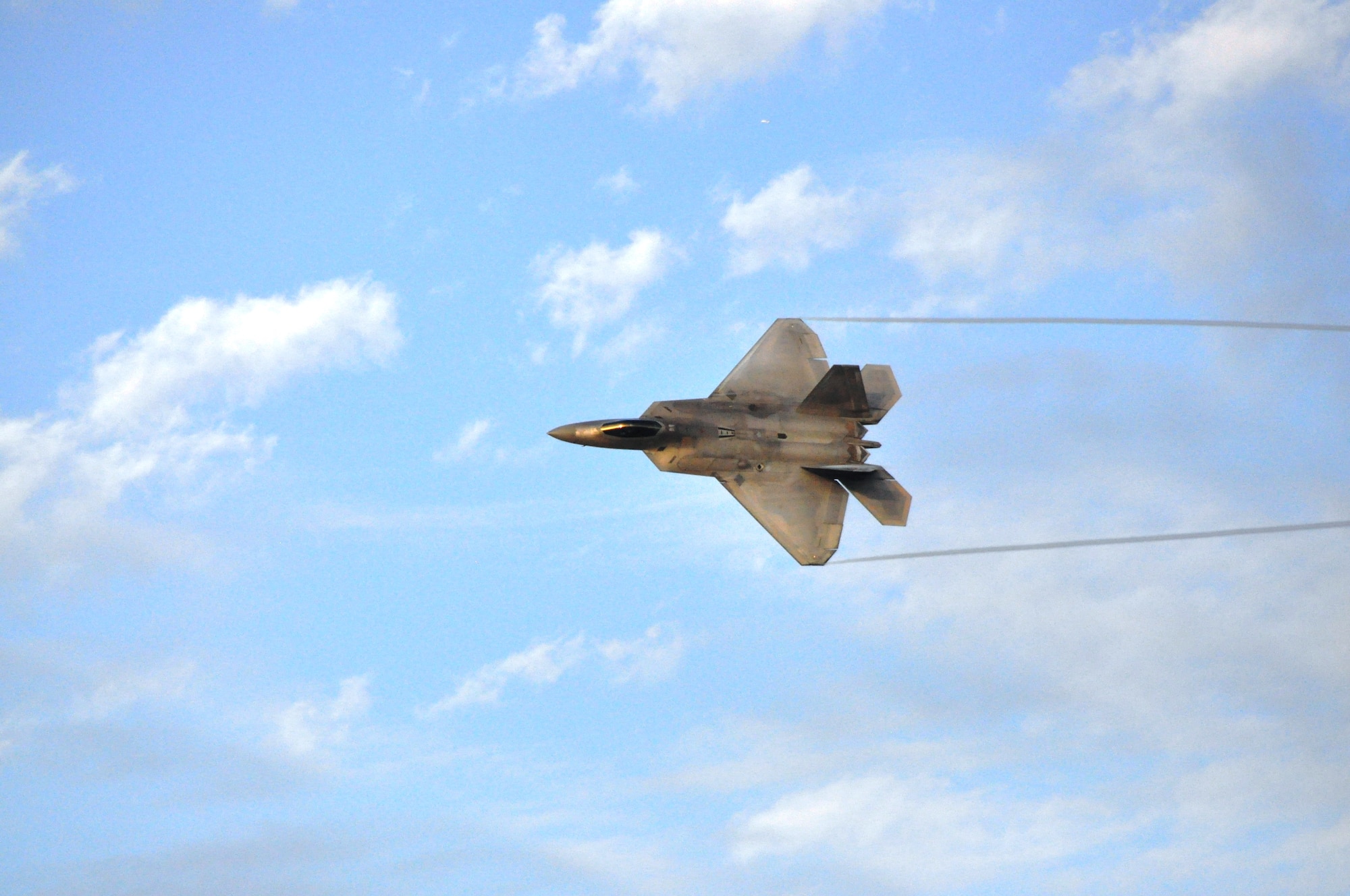Major Henry Schantz, 1st Fighter Wing F-22 demonstration pilot, Langley AFB, Va., took to the wide open blue skies of Tyndall Air Force Base in a practice F-22 Raptor demonstration run Feb. 8. (U.S Air Force photo by Lisa Norman)