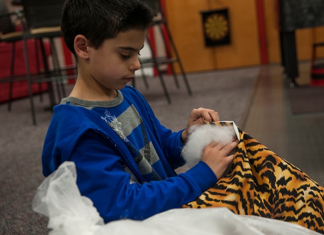 Matthew Hughes, stepson of Sgt. Luis Crovetto, Marine Corps Reserve Unit heavy equipment chief, stuffs a pillow Feb. 12, 2013, at Joint Base Charleston- Air Base Youth Program Center, S.C. 'Pillows for Troops' is an ongoing project at the Youth Program Center, where children ages 9 to 15 are able to make pillows for troops who are deployed overseas. The project takes place every Tuesday through Friday from 3:30 p.m. to 4:30 p.m. (U.S. Air Force photo/Airman 1st Class Ashlee Galloway)