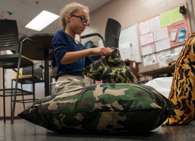 Danyelle Gibson, daughter of Tech. Sgt. Robert Alvarado, 437th Aircraft Maintenance Squadron communications and navigation systems craftsman, stuffs a pillow Feb. 12, 2013, at the Joint Base Charleston- Air Base Youth Program Center. 'Pillows for Troops' is an ongoing project at the Youth Program Center, where children ages 9 to 15 are able to make pillows for troops who are deployed overseas. The project takes place every Tuesday through Friday from 3:30 p.m. to 4:30 p.m. (U.S. Air Force photo/Airman 1st Class Ashlee Galloway)