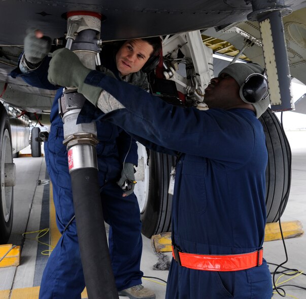 Airman 1st Class Keith Jackson, 707th Maintenance Squadron crew chief, disengages a fuel hose as Staff Sgt. James Hulett, 20th Aircraft Maintenance Unit, directs after refueling a B-52H Stratofortress on Barksdale Air Force Base, La., Feb. 13. B-52s can be fueled with up to 300,000 pounds of JP-8, giving them the ability to project air power from across the globe. (U.S. Air Force photo/Airman 1st Class Andrew Moua)