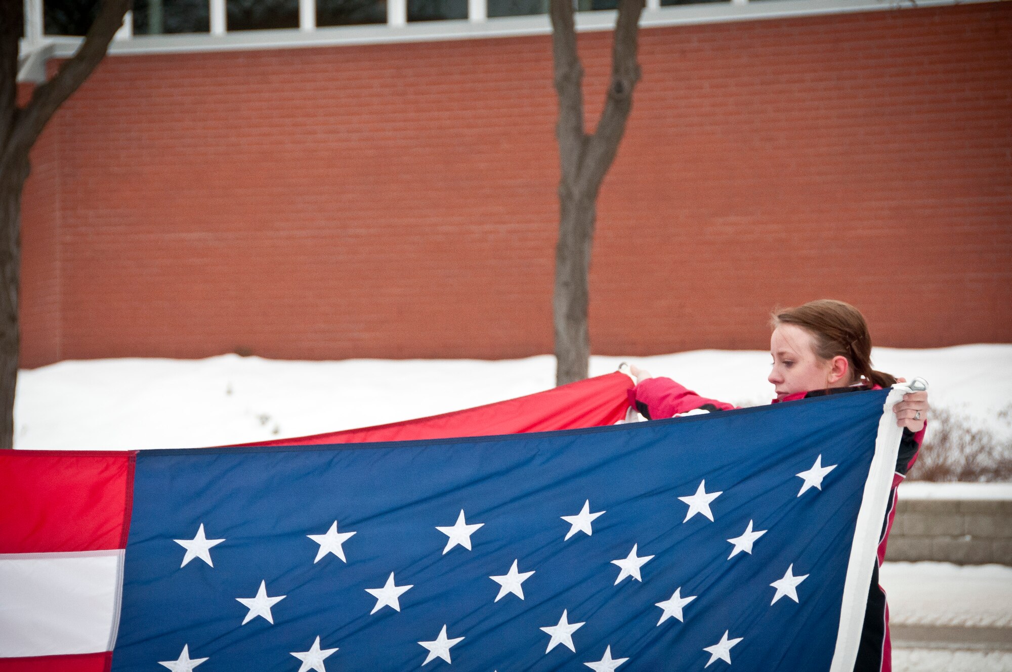 Morgan MacFarlane, a member of the 934th Development Training Flight, folds the flag during a retreat ceremony.  The 934 DTF was tasked to perform the reveille and retreat ceremonies during the February Unit Trainin Assembly at the Minneapolis-St. Paul Air Reserve Station, Minn.  (U.S. Air Force photo/Staff Sgt. Samantha Wagner)