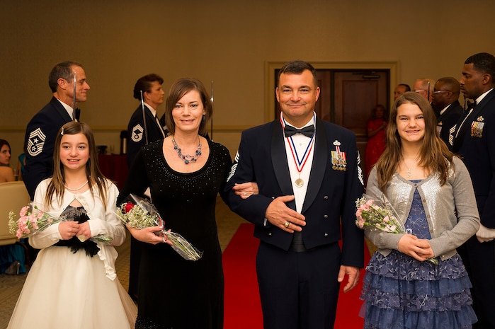 Chief Master Sgt. Ronald Johnson, 315th Maintenance Squadron flight chief, gathers with his family after walking through the saber team Feb. 9, 2013, during the Chief Recognition Ceremony at the Charleston Club at Joint Base Charleston – Air Base, S.C.  Johnson and nine other Airmen were inducted into the highest enlisted rank during the formal event. Chief master sergeants make up one percent of the Air Force's enlisted force. Senior Master Sgt. Jason Ellis, 437th Aircraft Maintenance Squadron superintendent, Chief Master Sgt. Bradley Levander, 81st Aerial Port Squadron, Chief Master Sgt. Neil Mann, 315th MXS Fabrication flight chief, Senior Master Sgt. Dexter McIlwain, 38th Aerial Port Squadron, Senior Master Sgt. Jan Menard, 628th Aerospace Medicine Squadron Bioenvironmental Engineering flight, Senior Master Sgt. Wendell Simms, 628th Contracting Squadron superintendent, Chief Master Sgt. David Turner, 315th MXS Accessories flight, Chief Master Sgt. Bart Walters, 315th Aeromedical Evacuation Squadron and Cheryl Clark, Holiday Inn Express hotels general manager and 437th Airlift Wing Honorary Commander, were all inducted during the event. (U.S. Air Force photo/Senior Airman George Goslin)
