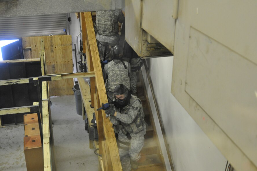 Defenders from the 55th Security Forces Squadron proceed up the stairwell in the new shoot house during an active shooter demonstration on Feb. 5. (U.S. Air Force Photo by 2nd Lt. Carly Costello/Released)