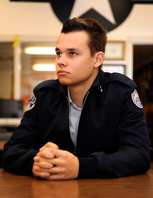 Julian Kandt, Douglas High School Air Force junior ROTC cadet, listens to morning announcements at Douglas High School in Box Elder, S.D., Feb. 11, 2013. Cadets in the program practice standing at attention, facing movements, proper grooming and uniform care, and military courtesies during class and through other activities, such as physical training, color guard and drill team. (U.S. Air Force photo by Airman Ashley J. Thum/Released)