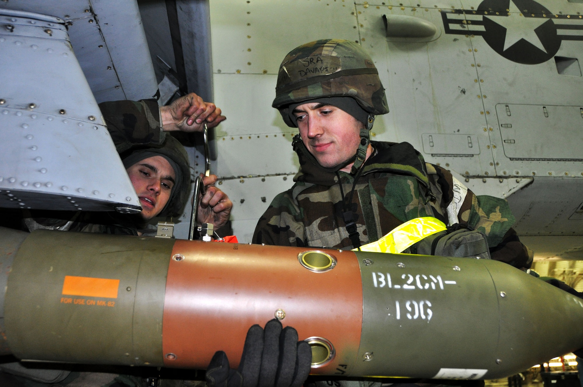 Senior Airman Steven Davarich, 51st Maintenance Operations Squadron lead crew member, holds munitions in place while Senior Airman Joel Valdez, 51st MOS lead crew member, ensures its secure during operational readiness exercise Beverly Bulldog 13-02 Feb. 13, 2013 at Osan Air Base, Republic of Korea.  The team conducted a half up- half down procedure on an A-10 Thunderbolt II, which gives them a realistic time standard for munitions loading during real world contingencies. 