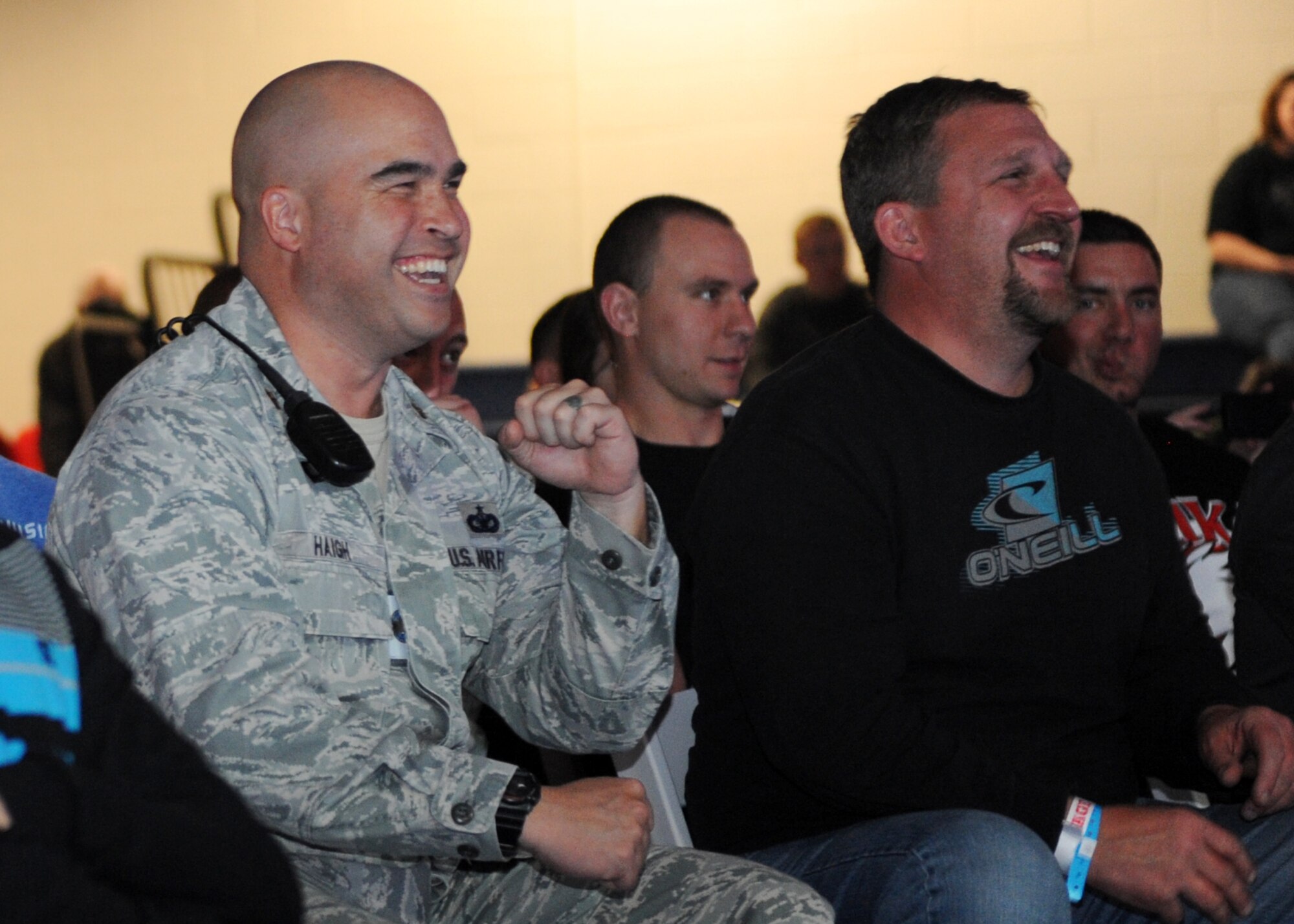 Maj. David Haigh, 460th Security Forces Squadron commander, cheers at the Buckley MMA Fight Night Feb. 9, 2013, at the Buckley Air Force Base Fitness Center. Security Forces Airmen provided security for the event which included eight fights aired on pay-per-view to benefit the Wounded Warrior Project. (U.S. Air Force photo by Senior Airman Marcy Glass/Released)