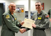 Col. Terry Scott, 15th Wing vice commander, presents a certificate to Caleb Jensen, aplastic anemia survivor, after his Pilot For a Day tour on Joint Base Pearl Harbor Hickam, Hawaii, Feb. 8, 2013. Caleb, whose dream it is to one day become a pilot, was selected for the Pilot For a Day program after being diagnosed with aplastic anemia, a condition which causes the body to stop producing new blood cells. (U.S. Air Force photo/Tech. Sgt. Jerome S. Tayborn)