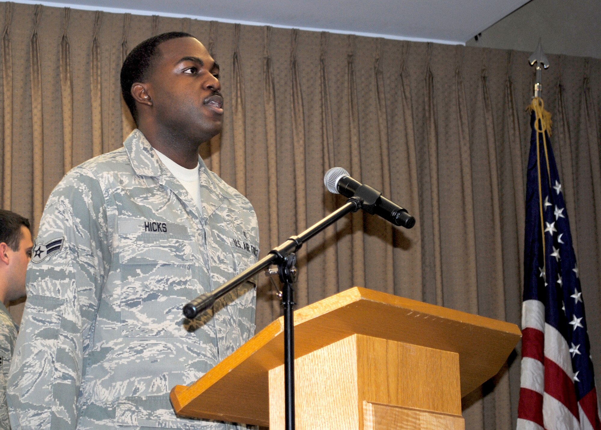 Airman 1st Class Andrew Hicks, from the 319th Medical Operations Squadron, helps kick off the start of the 2013 Honorary Commander Induction Ceremony by singing the national anthem Feb. 8, 2013, at the Northern Lights Club on Grand Forks Air Force Base, N.D.  (U.S. Air Force photo/Senior Airman Luis Loza Gutierrez)