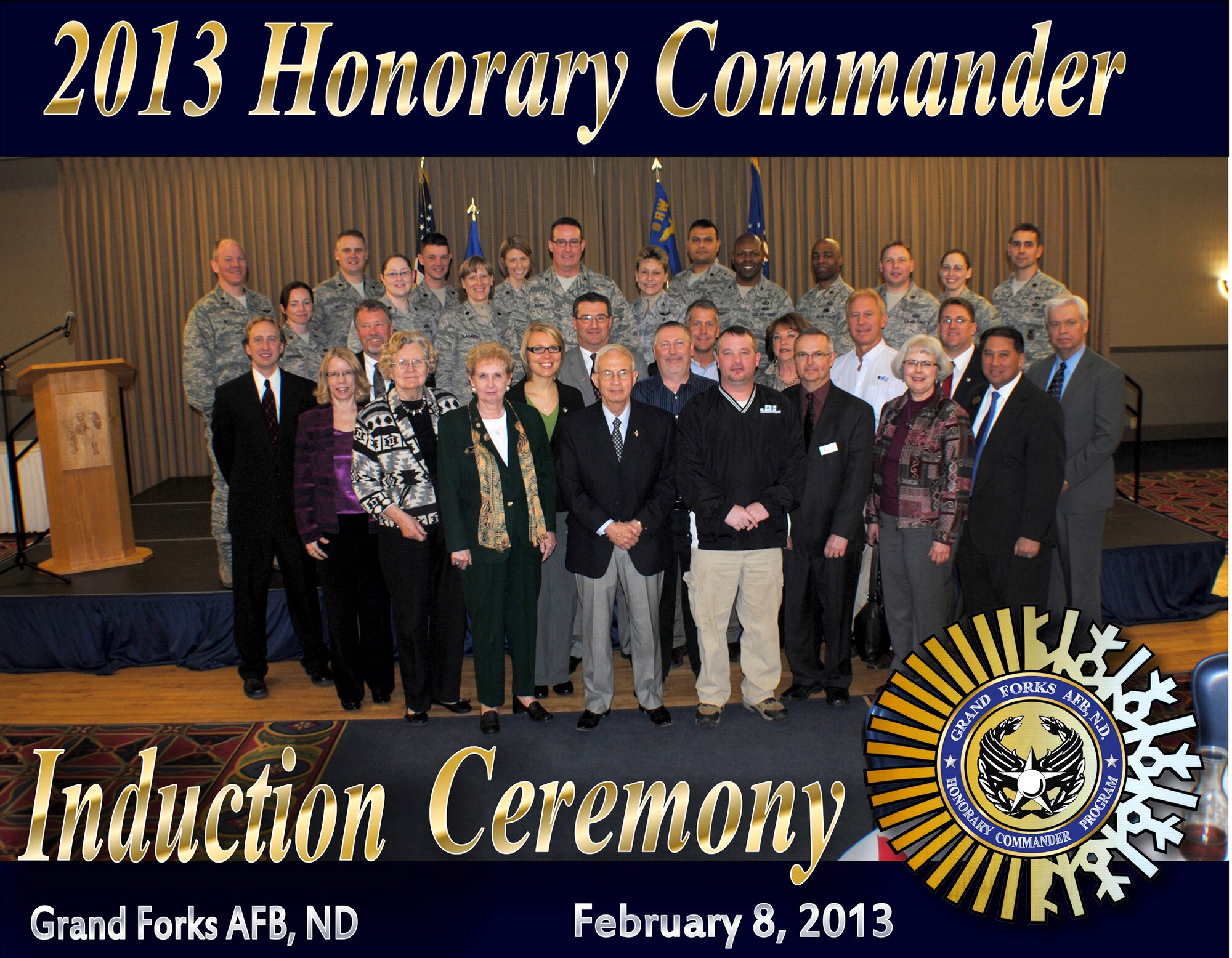 Grand Forks Air Force Base commanders, base ambassadors and honorary commanders take to the stage for a group photo to commemorate the installation’s 2013 Honorary Commander Induction Ceremony on Feb. 8, 2013 at the Northern Lights Club on Grand Forks AFB, N.D. (U.S. Air Force photo illustration/Senior Airman Luis Loza Gutierrez)