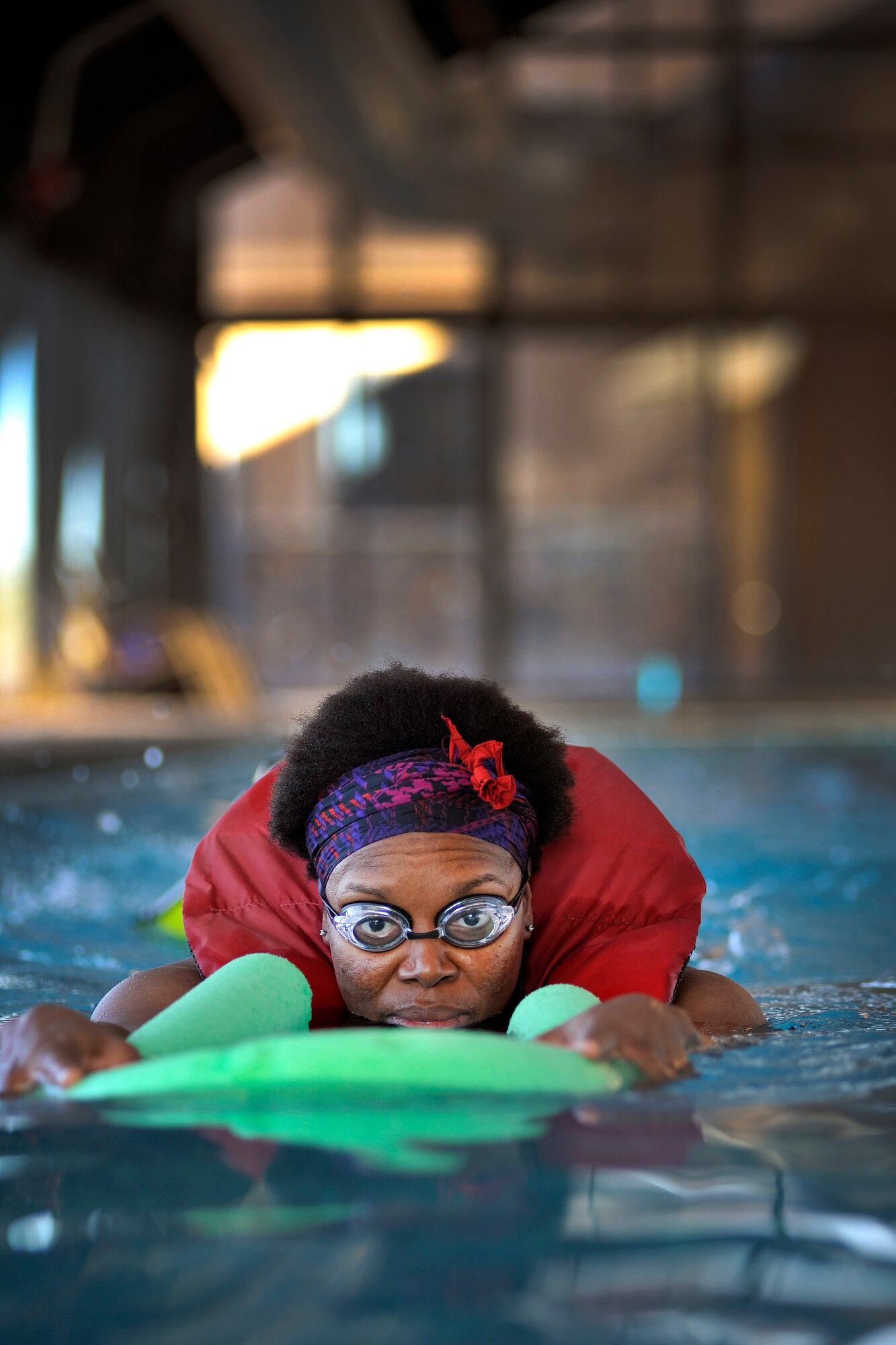 Tech. Sgt. Tawanna Sellars, 50th Space Wing Safety office, swims at the Tierra Vista Community pool as part of the Lazyman Triathlon Feb. 13.  Sellars, a fledgling swimmer, is half way through her 77 laps in the event.  (U.S. Air Force Photo/Dennis Rogers)