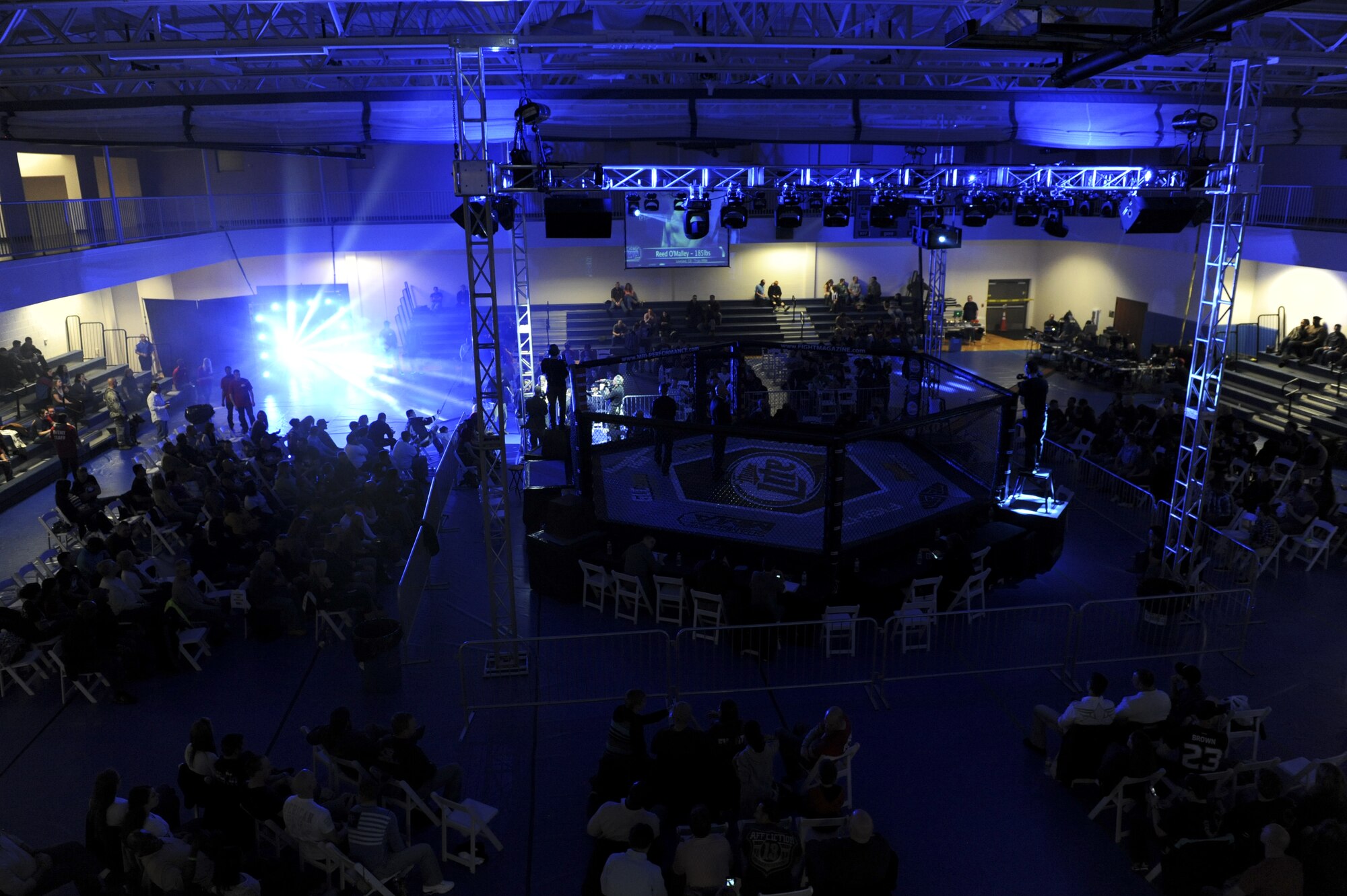 The crowd watches fighters at the Buckley MMA Fight Night Feb. 9, 2013, at Buckley Air Force Base.  This event was the first sanctioned mixed martial arts event on a Colorado military base.  (U.S. Air Force photo by Airman 1st Class Phillip Houk/Released)