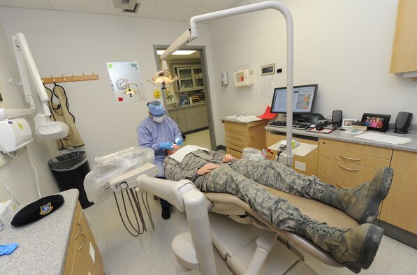 WHITEMAN AIR FORCE BASE, Mo. -- Staff Sgt. Jessica Sykes, 509th Medical Operations Squadron dental technician, performs a cleaning on a patient, Feb. 4. The primary mission of the dental flight is dental readiness and ensuring Airmen are worldwide qualified for deployment throughout the year. (U.S. Air Force photo/Staff Sgt. Nick Wilson) (Released)