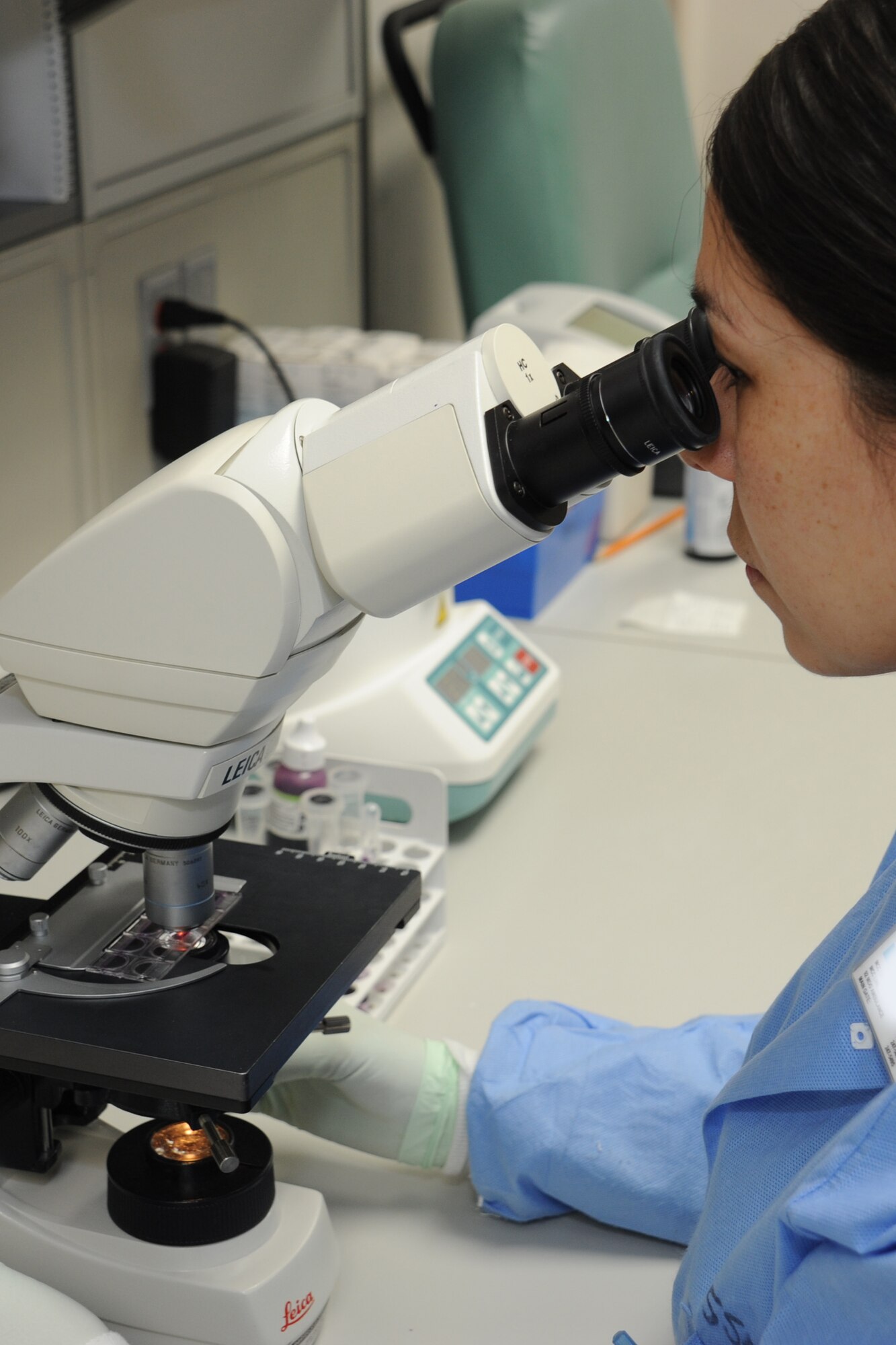 Staff Sgt.  Jessica Portilla, 92nd Medical Support Squadron laboratory technician, looks through a microscope at a gram stain slide to determine the presence or absence of bacteria in a urine sample in the lab at Fairchild Air Force Base, Wash., Feb. 8, 2013. The lab tech can go through an average of 75 to 100 blood samples and other specimens daily. (U.S. Air Force photo by Senior Airman Jordan Pollock) 