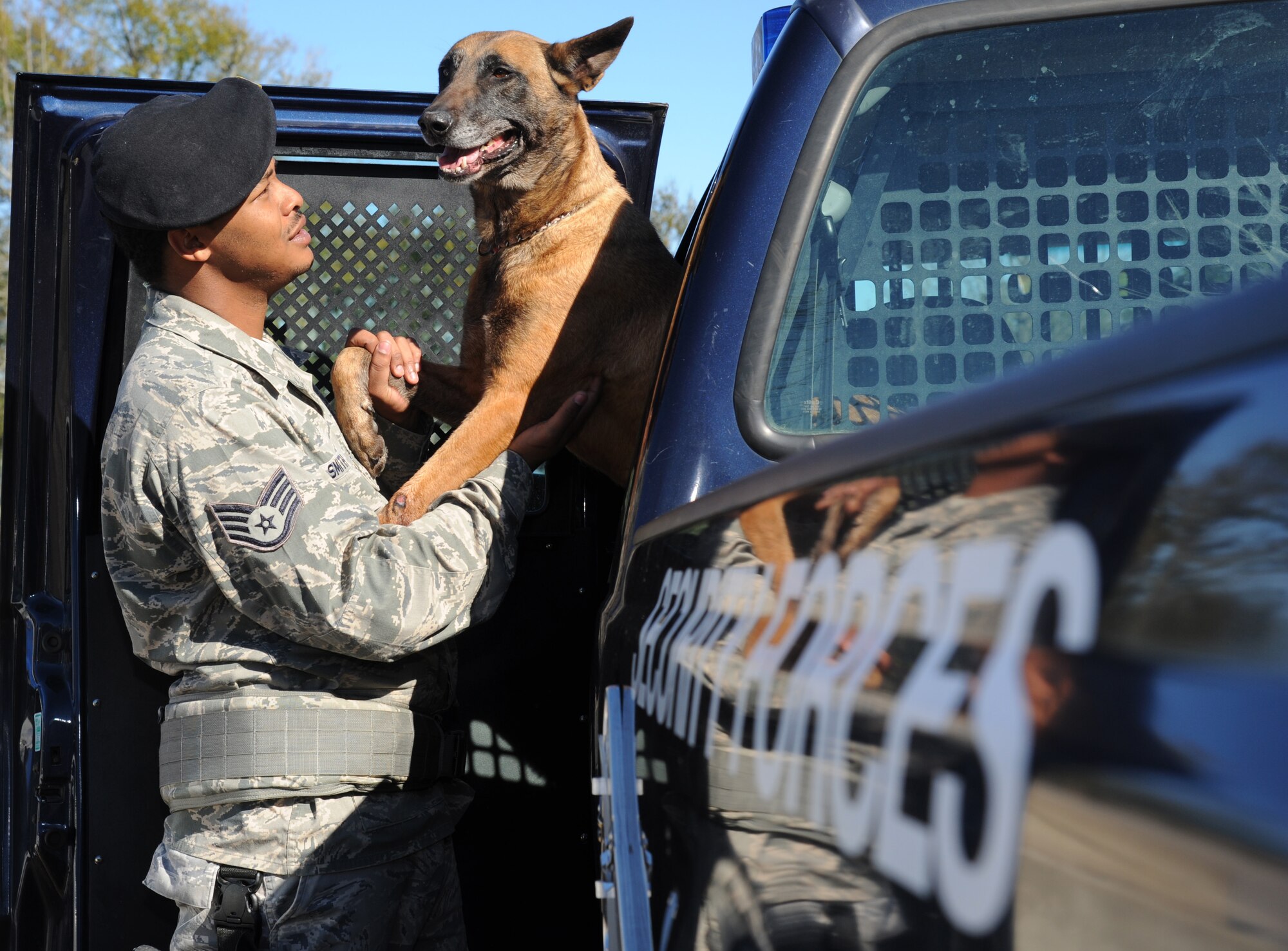 Staff Sgt. Kyle Smith, 81st Security Forces Squadron, and his military working dog, Densy, spend some bonding time together while waiting for a vehicle inspection at Keesler Air Force Base, Miss., Jan. 31, 2013. Recent studies suggest that military working dogs may be subject to post-traumatic stress disorder, much like their human counterparts.  (U.S. Air Force photo by Kemberly Groue)
