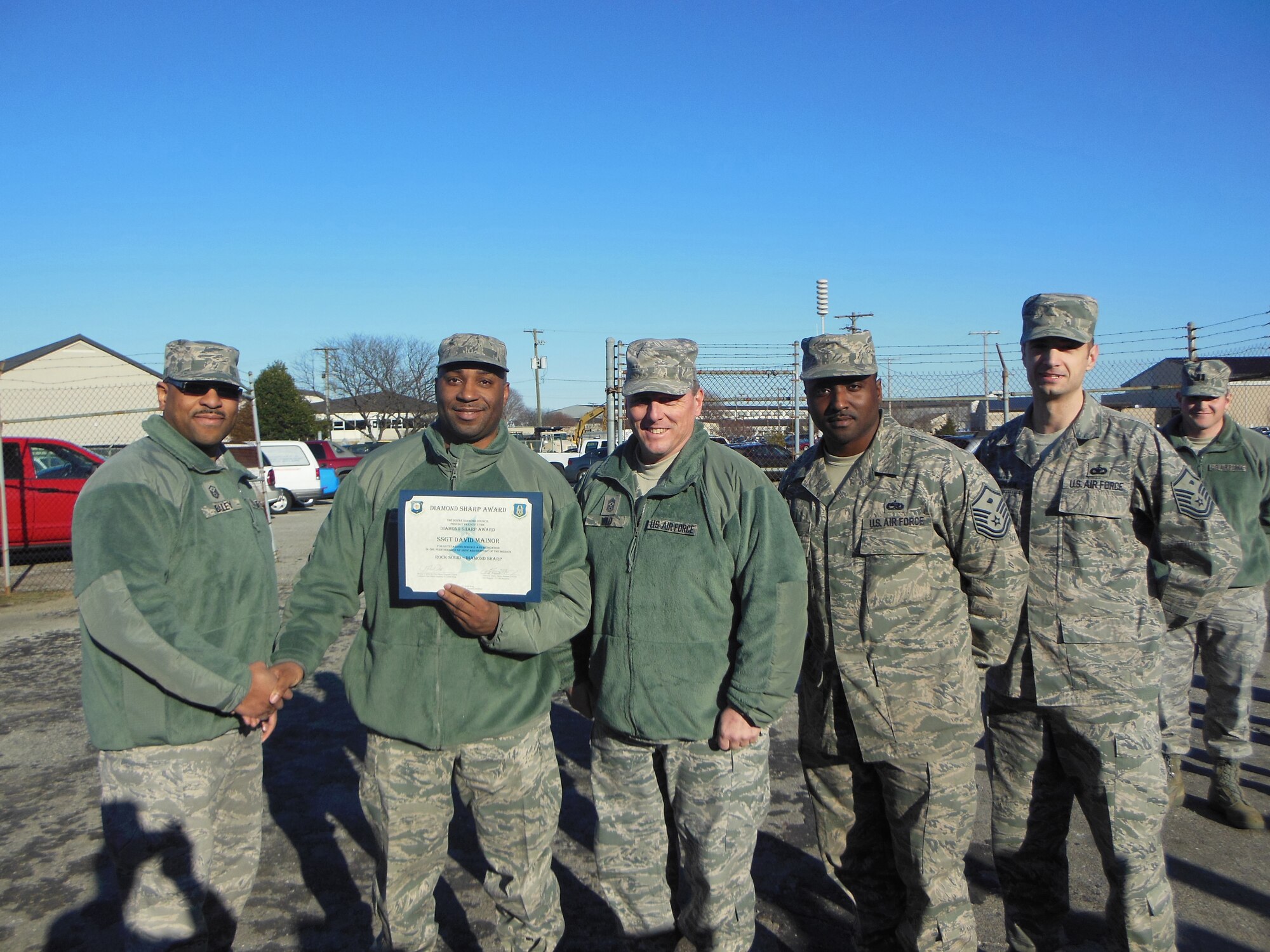 Staff Sgt. David Mainor (second from left), 512th Civil Engineer Squadron engineer assistant, displays his Diamond Sharp Award presented to him by Master Sgt. Clifford Bailey (first from left), the 512th CES first sergeant, Feb. 10, 2013, here. The award recognized Mainor's service and dedication to the performance of his duty and support of the civil engineer mission. Also present for the presentation was Chief Master Sgt. William T. Wild III, the 512th Airlift Wing Command Chief and two other first sergeants. (U.S. Air Force photo/Staff Sgt. Karista Laise)