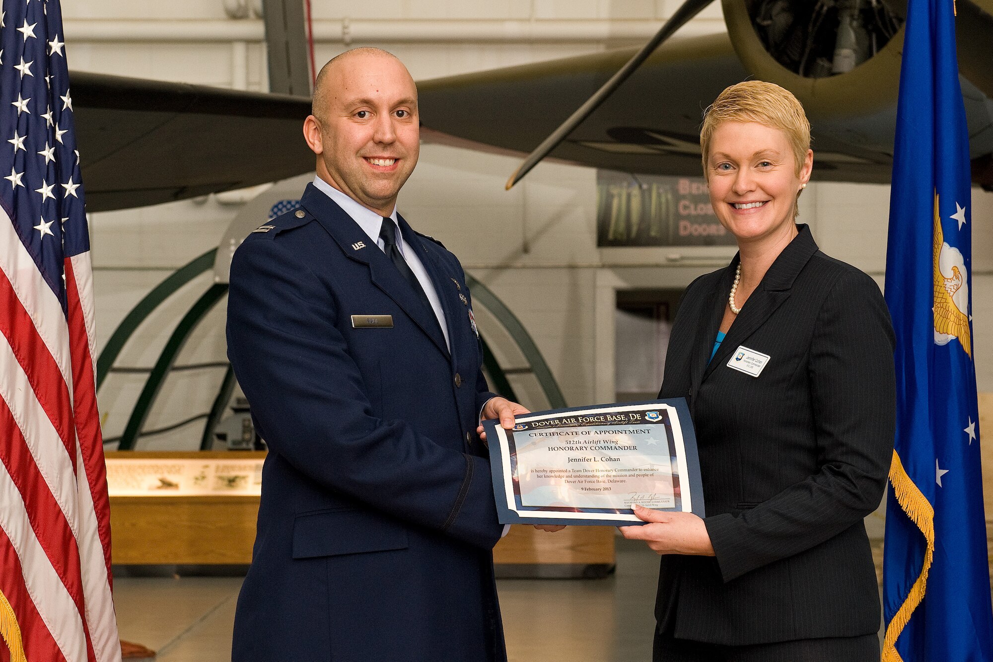 Capt. Brian Saul, 512th Logistics Readiness Squadron commander, presents a certificate of induction to Jennifer Cohan, Division of Motor Vehicles director in Dover, Del., at a ceremony and dinner at the Air Mobility Command Museum, in Dover, Del., Feb. 9, 2013. Cohan is one of 19 civic leaders selected to participate in the Reserve unit’s Honorary Commander Program, which is designed to strengthen the ties between the base and the community. (U.S. Air Force photo/Roland Balik)