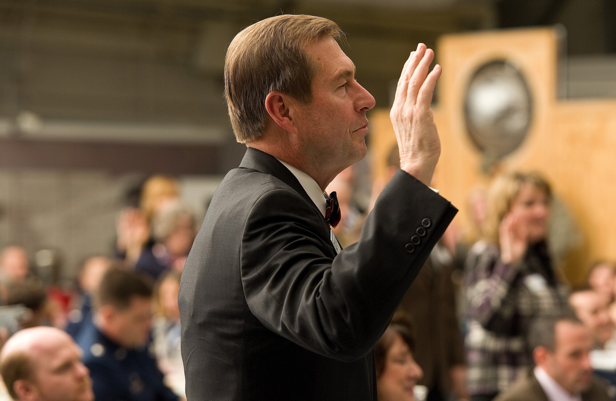 Dr. William Johnston, the president of Wesley College, takes an oath to serve as an ambassador of the Air Force and his community as part of the Honorary Commander Program during an induction ceremony and dinner Feb. 9, 2013, at the Air Mobility Command Museum, in Dover, Del. Johnston will serve as an honorary commander for the 512th Operations Group, an associate Reserve unit, which flies C-5 and C-17 aircraft.  (U.S. Air Force photo/Roland Balik)