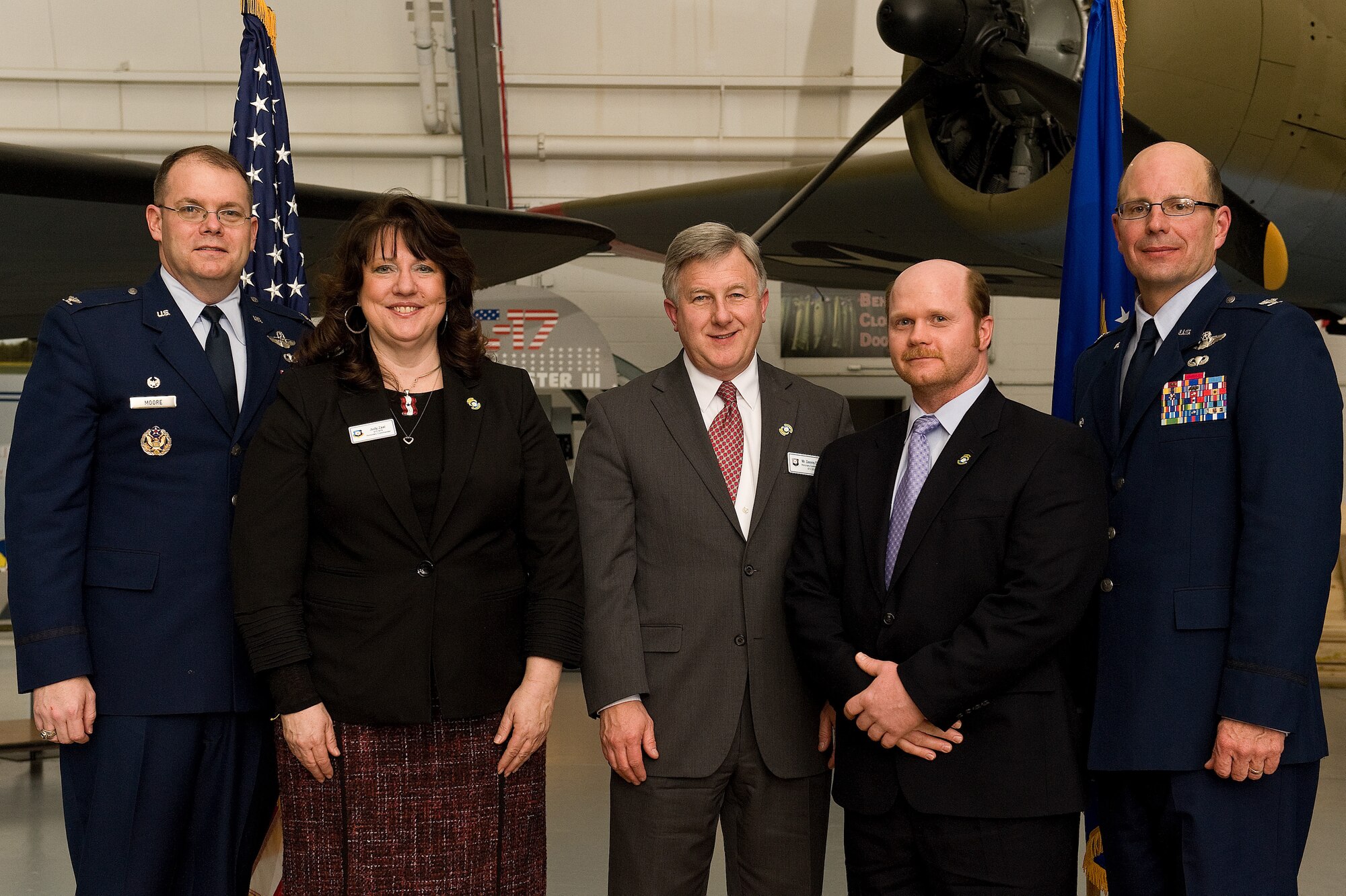 Col. Richard G. Moore Jr. (left) and Col. Raymond A. Kozak, 436th and 512th Airlift Wing commanders,   stand with three 2012 honorary commanders, who were inducted into the alumni program Feb. 9, 2013, during a ceremony and dinner at the Air Mobility Command Museum, Dover, Del. From left to right are Judy Zaal, Dennis Doll and Rob Moran. (U.S. Air Force photo/Roland Balik)