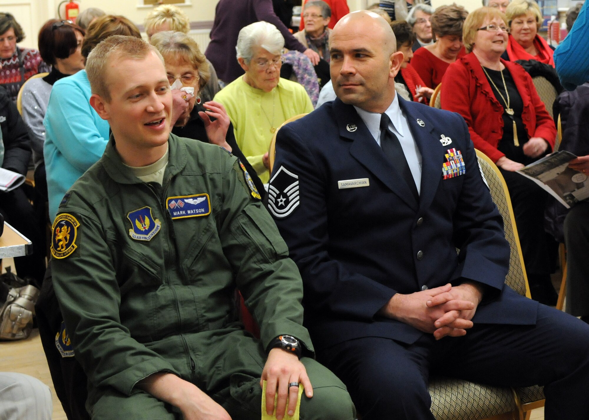 From left, Capt. Mark Watson, 100th Operations Support Squadron executive officer, from Rockwall, Texas, and Master Sgt. Jalil Samavarchian, 100th Maintenance Squadron Aircraft Metals Technology section chief from Los Gatos, Calif., greet each other before speaking at a Women’s Institute meeting Feb. 12, 2013 in Barton Mills, England. The speakers talked about life on base and living overseas. (U.S. Air Force photo by Airman 1st Class Kelsey Waters/Released)