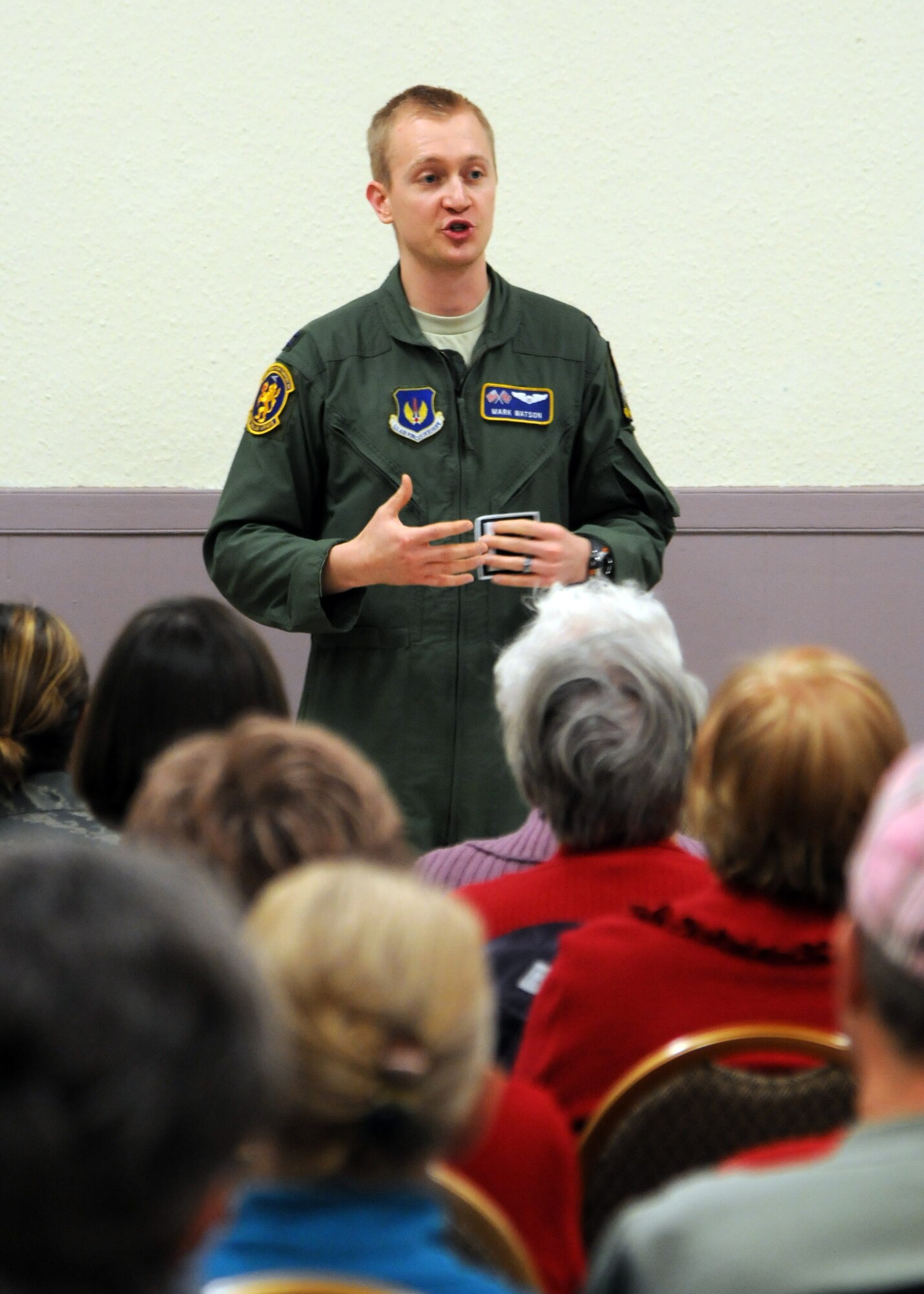 Capt. Mark Watson, 100th Operations Support Squadron executive officer, from explains the history behind the Square D patch to members of the Women’s Institute, during a meeting Feb. 12, 2013 in Barton Mills, England. Watson a Rockwall, Texas, native, also spoke about his experiences living in England as a U.S. service member. (U.S. Air Force photo by Airman 1st Class Kelsey Waters/Released)