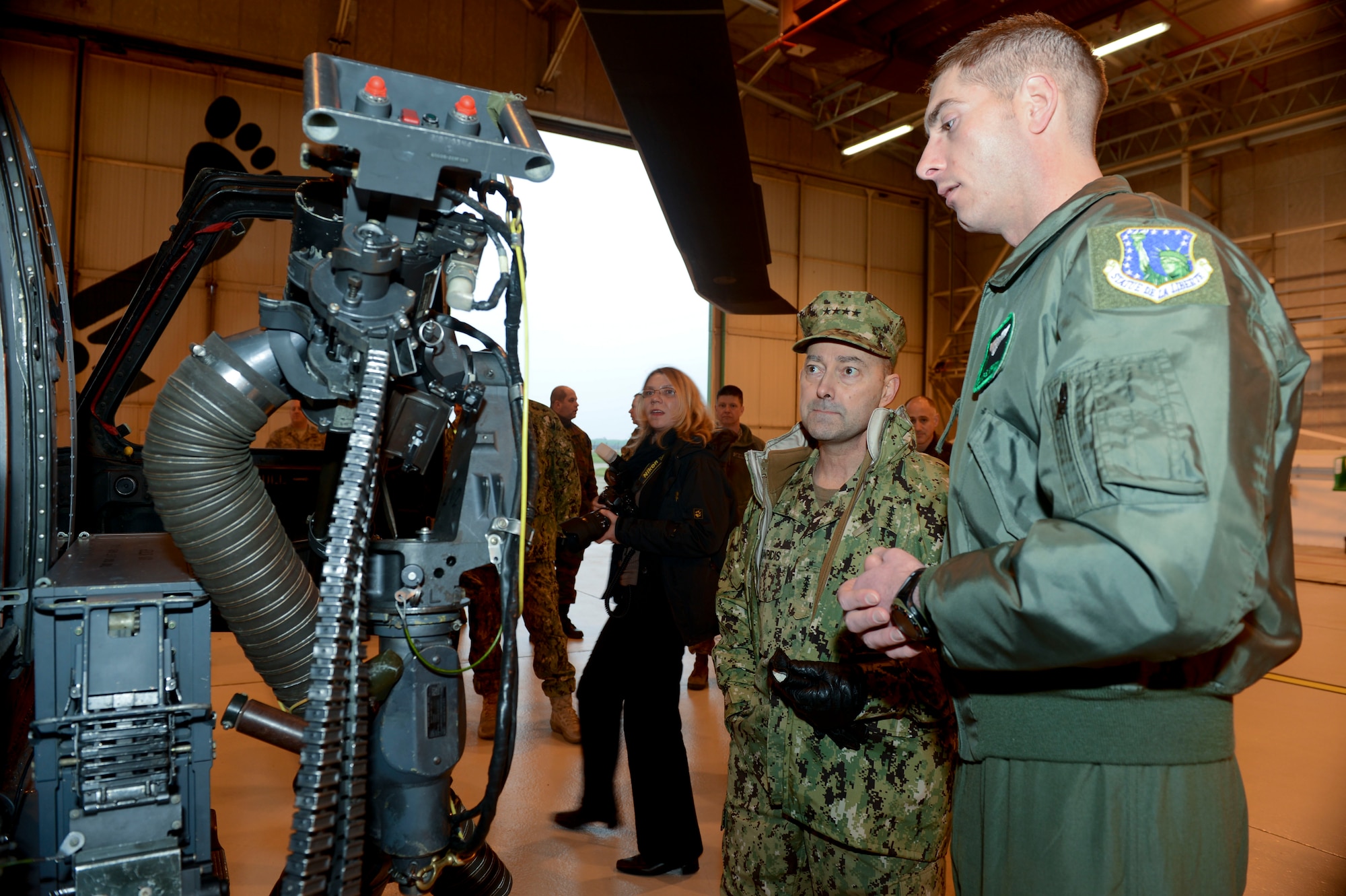 ROYAL AIR FORCE LAKENHEATH, England - Tech. Sgt. Michael Morrison (right), 56th Rescue Squadron special mission aviator evaluator and native of Salisbury, Mo., shows U.S. Navy Adm. James G. Stavridis (left), U.S. European Command commander and NATO Supreme Allied Commander Europe, a GAU-2C mini-gun on an HH-60G Pave Hawk Feb. 12, 2013. The admiral toured RAFs Mildenhall and Lakenheath to visit U.S. and NATO assets assigned in the U.K. (U.S. Air Force photo by Staff Sgt. Stephen Linch)