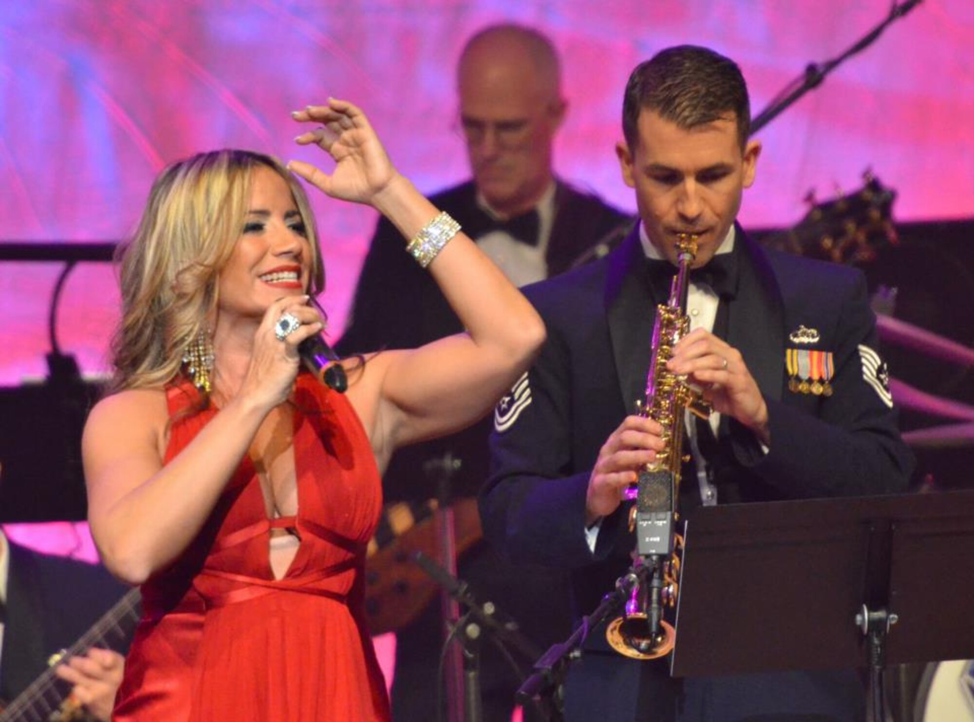 Melina León sings a beautiful tune, as TSgt Tyler Keubler plays along. (photo by SMSgt Robert Kamholz)
 
