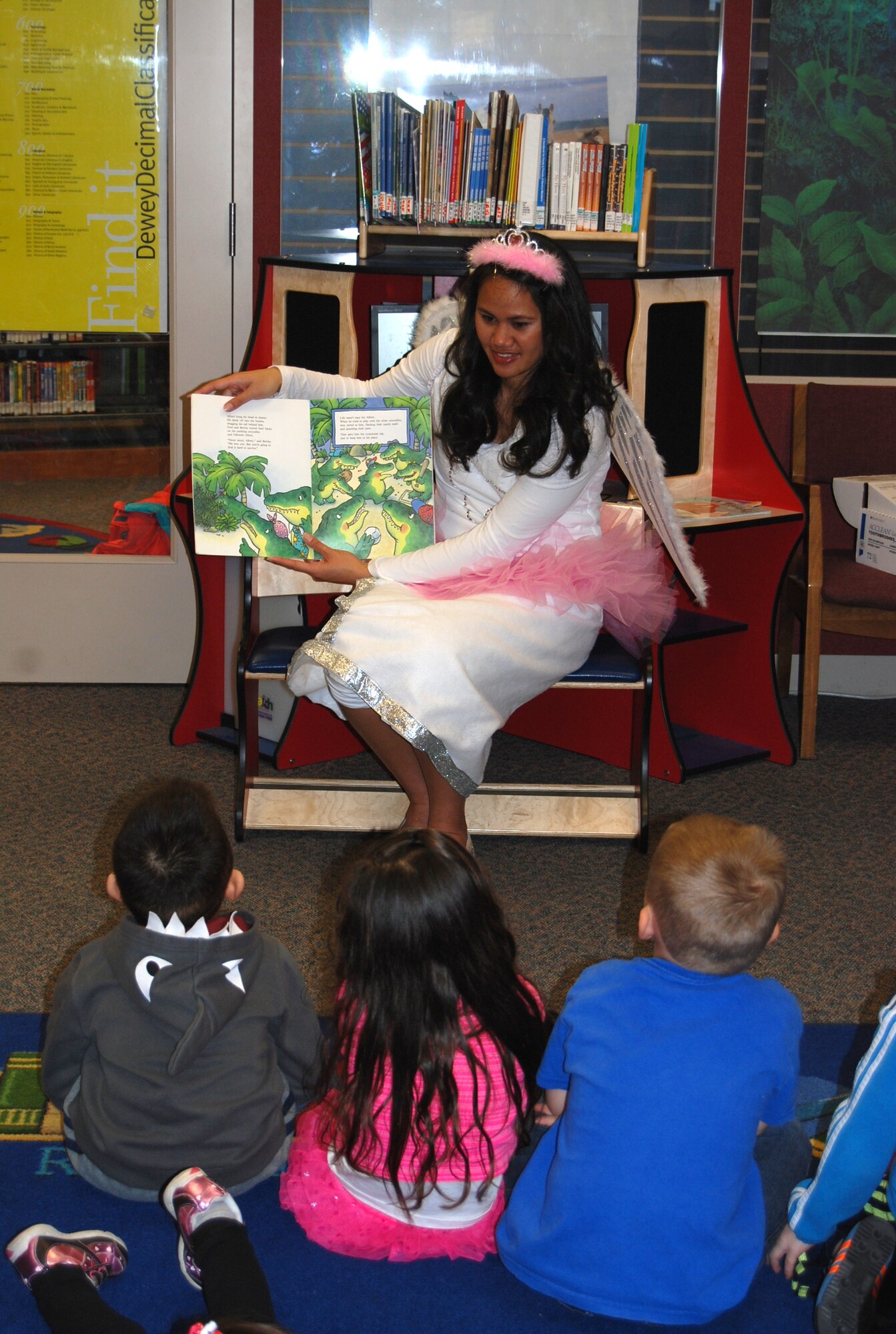 PETERSON AIR FORCE BASE, Colo. -- The tooth fairy visits story time at the Peterson Air Force Base library Feb. 6 as part of Children’s Dental Health Month. She read stories to the children about the tooth fairy and going to the dentist, and finished her visit by passing out toothbrushes and toothpaste for the children. (U.S. Air Force photo/Lea Johnson)