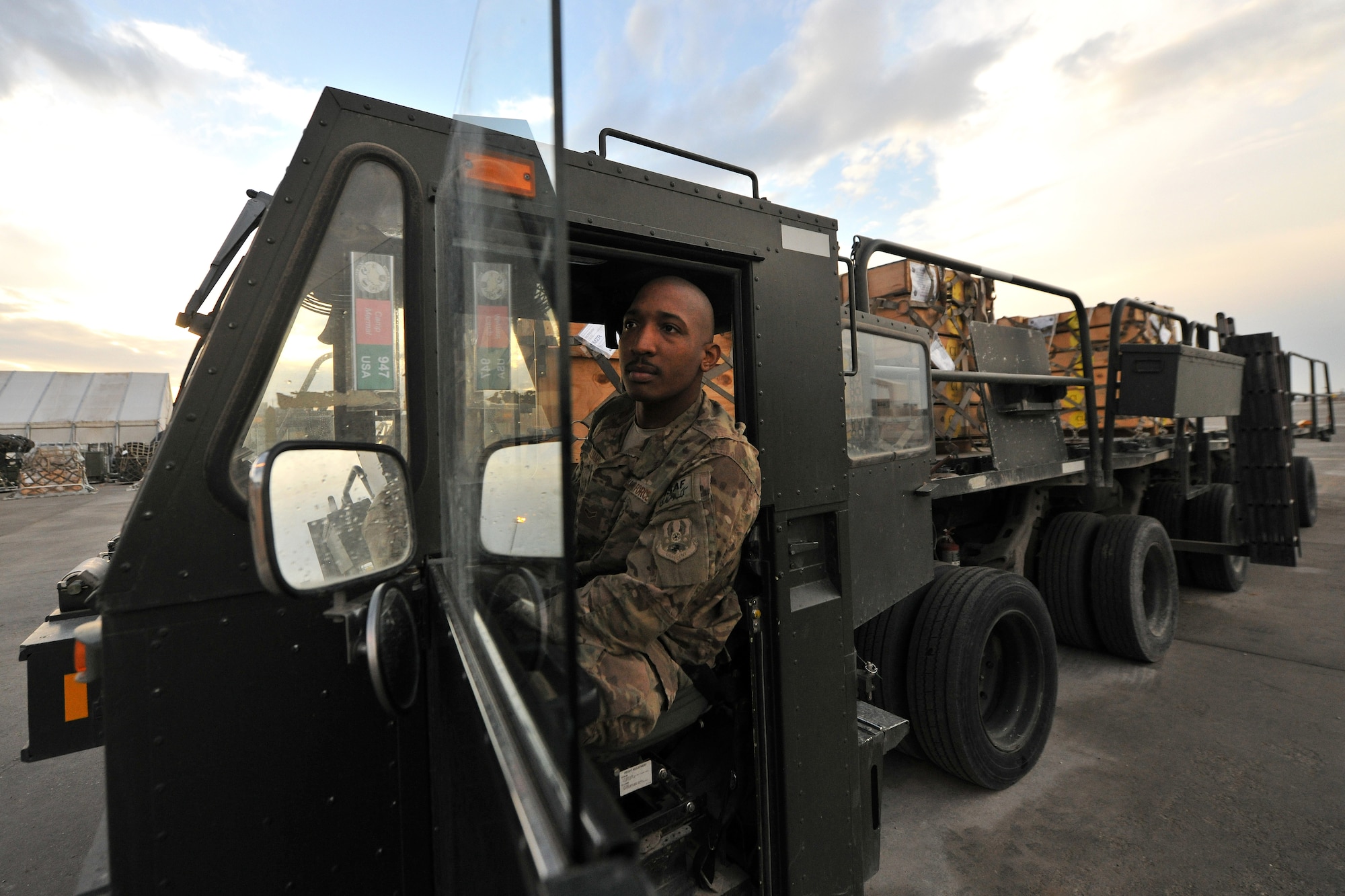 Airman 1st Class Robert Williams, 455th Expeditionary Aerial Port Squadron, Detachment 3 Aerial Port specialist, drives a 60K aircraft loader across the contingency cargo staging yard at Camp Marmal, Afghanistan, Jan 30, 2013. The port Airmen move more than 2,600 tons of cargo and 2,200 personnel each month in support of combat sustainment operations.  (U.S. Air Force photo/Senior Airman Chris Willis)