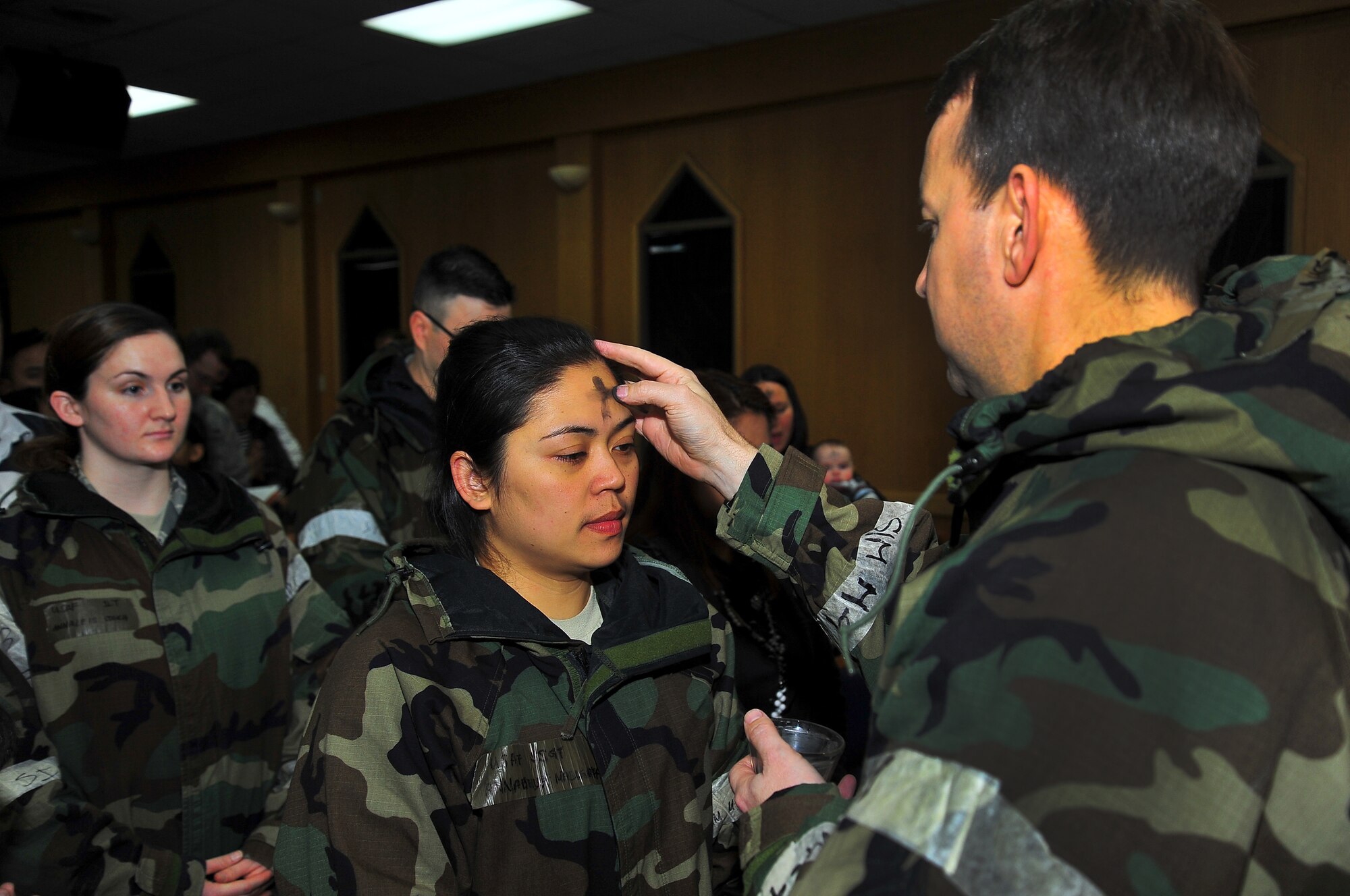 Staff Sgt. Annabelle Maligaya , 51st Force Support Squadron honor guard member, is marked with ashes during the Ash Wednesday Mass at the chapel  on Osan Air Base, Republic of Korea, Feb.13, 2013. The ceremony was held during the operational readiness exercise, Beverly Bulldog 13-02. Ash Wednesday marks the beginning of the Season of Lent.  (U.S. Air Force photo/Staff Sgt. Emerson Nuñez)