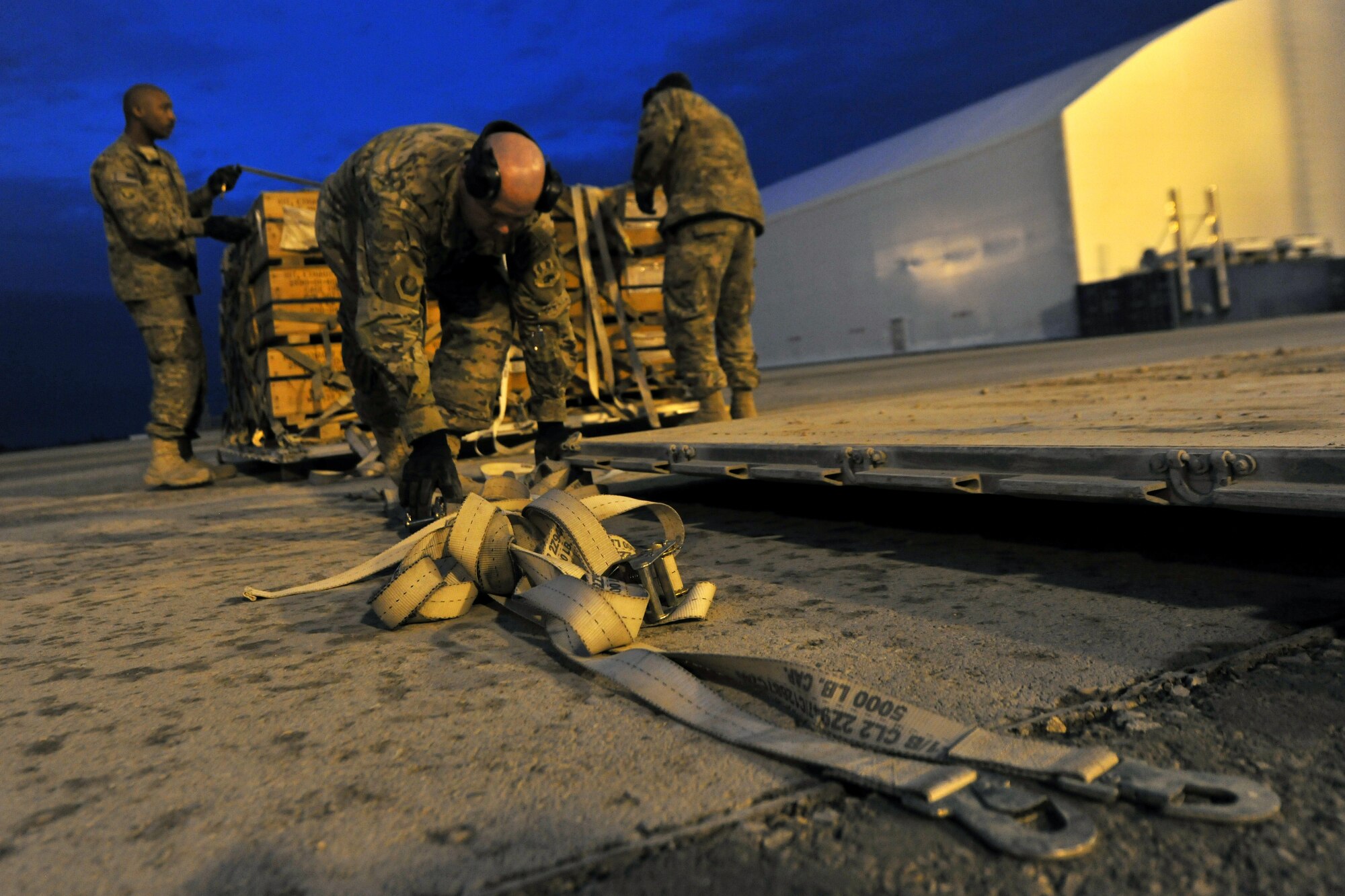 Airmen from 455th Expeditionary Aerial Port Squadron, Detachment 3, build pallets at the contingency cargo staging yard on Camp Marmal, Afghanistan, Jan 30, 2013. Airmen from the 455th EAPS are forward deployed from Bagram Airfield, Afghanistan, to support the main Air Force contingency cargo staging yard in Regional Command-North. (U.S. Air Force photo/Senior Airman Chris Willis)