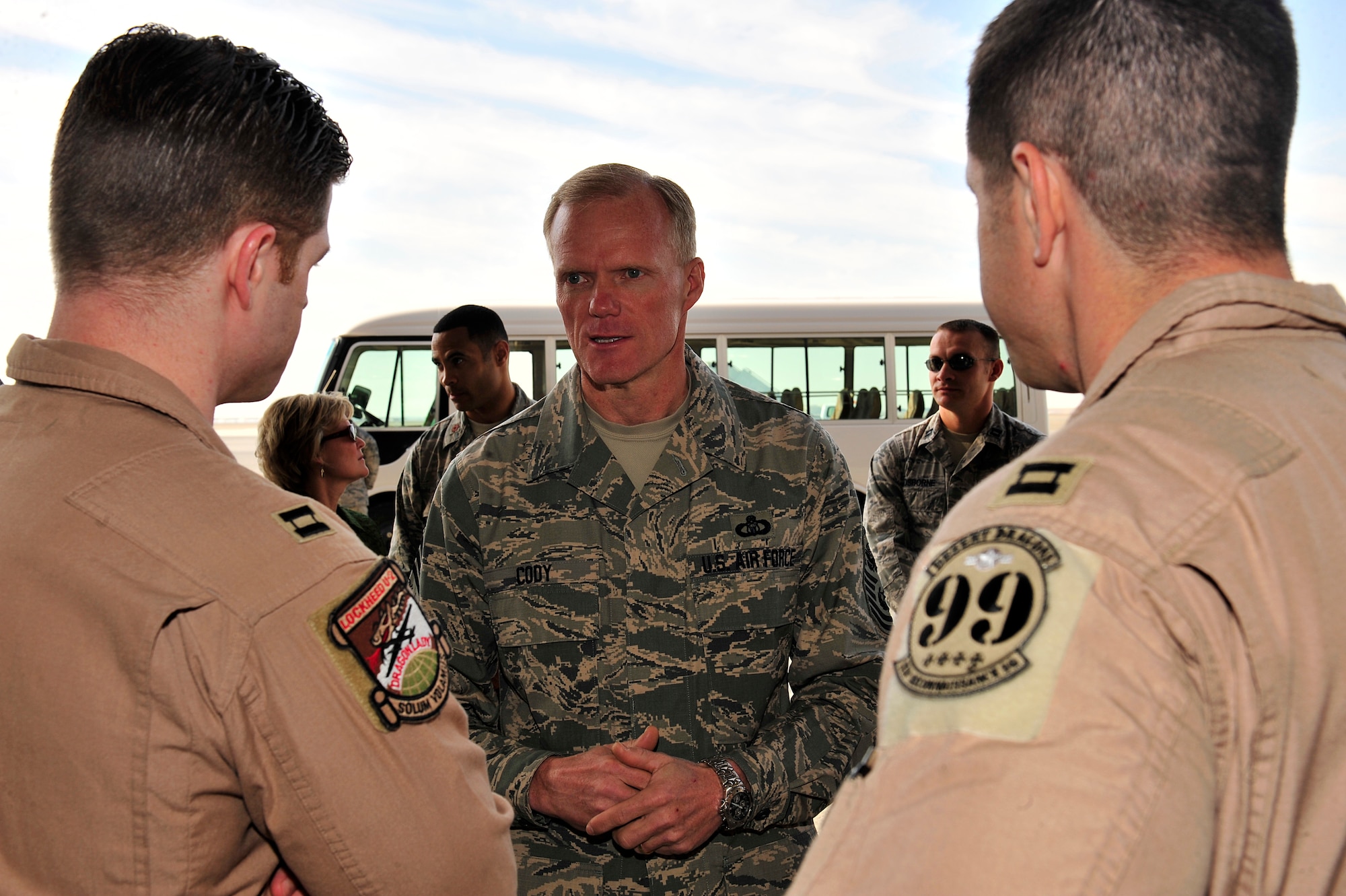 SOUTHWEST ASIA -- Chief Master Sgt. of the Air Force James Cody discusses the intelligence, surveillance and reconnaissance capabilities of the RQ-4 Global Hawk and the U-2 Dragon Lady with Capts. Greg Mansfield and Geoff Jernigan, 99th Expeditionary Reconnaissance Squadron pilots, Feb. 7, 2013. Cody and Air Force Chief of Staff Gen. Mark A. Welsh III visited the 380th Air Expeditionary Wing during a multi-base tour to meet with Airmen who are deployed throughout the U.S. Central Command area of responsibility. (U.S. Air Force photo/Tech. Sgt. Christina M. Styer)