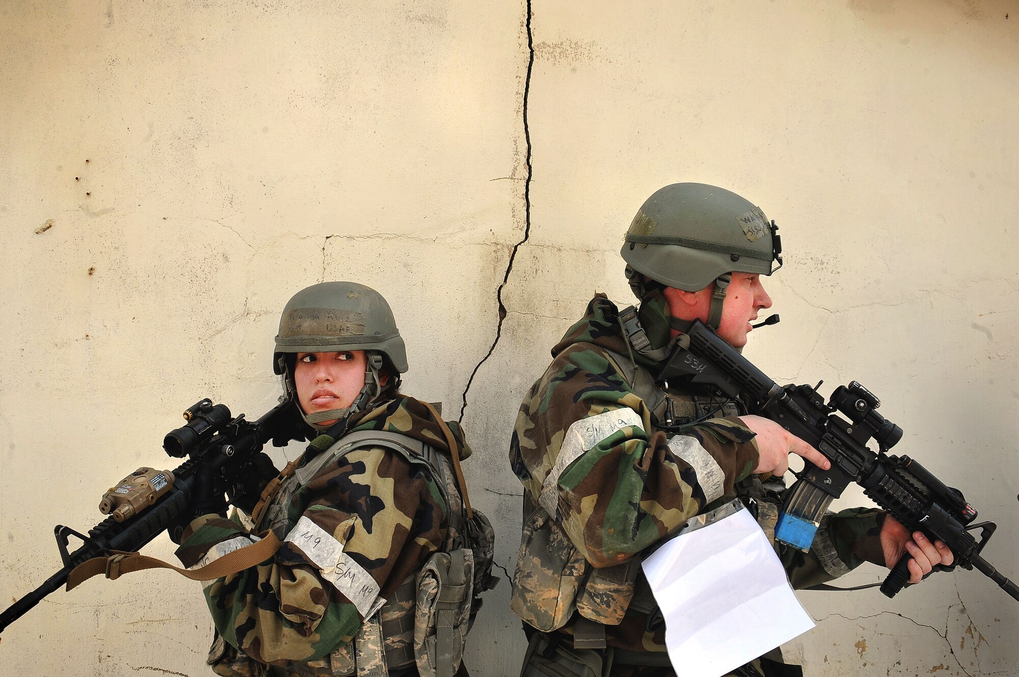 Staff Sgt. Arianna Ruiz and Staff Sgt. Franklin Walton, 51st Security Forces members, secure a building of enemy threats during a counter surveillance scenario for an operation readiness exercise, Beverly Bulldog 13-02 at Osan Air Base, Republic of Korea, Feb. 12, 2013. Counter surveillance scenarios are conducted to help train SF Airmen to deny opposing forces entry to the base and OREs tests Osan Airmen’s abilities during a heightened state of readiness while providing combat ready forces for close air support, air strike control, counter air, interdiction, theater airlift, and communications in the defense of the Republic of Korea. (U.S. Air Force photo/Staff Sgt. Sara Csurilla)