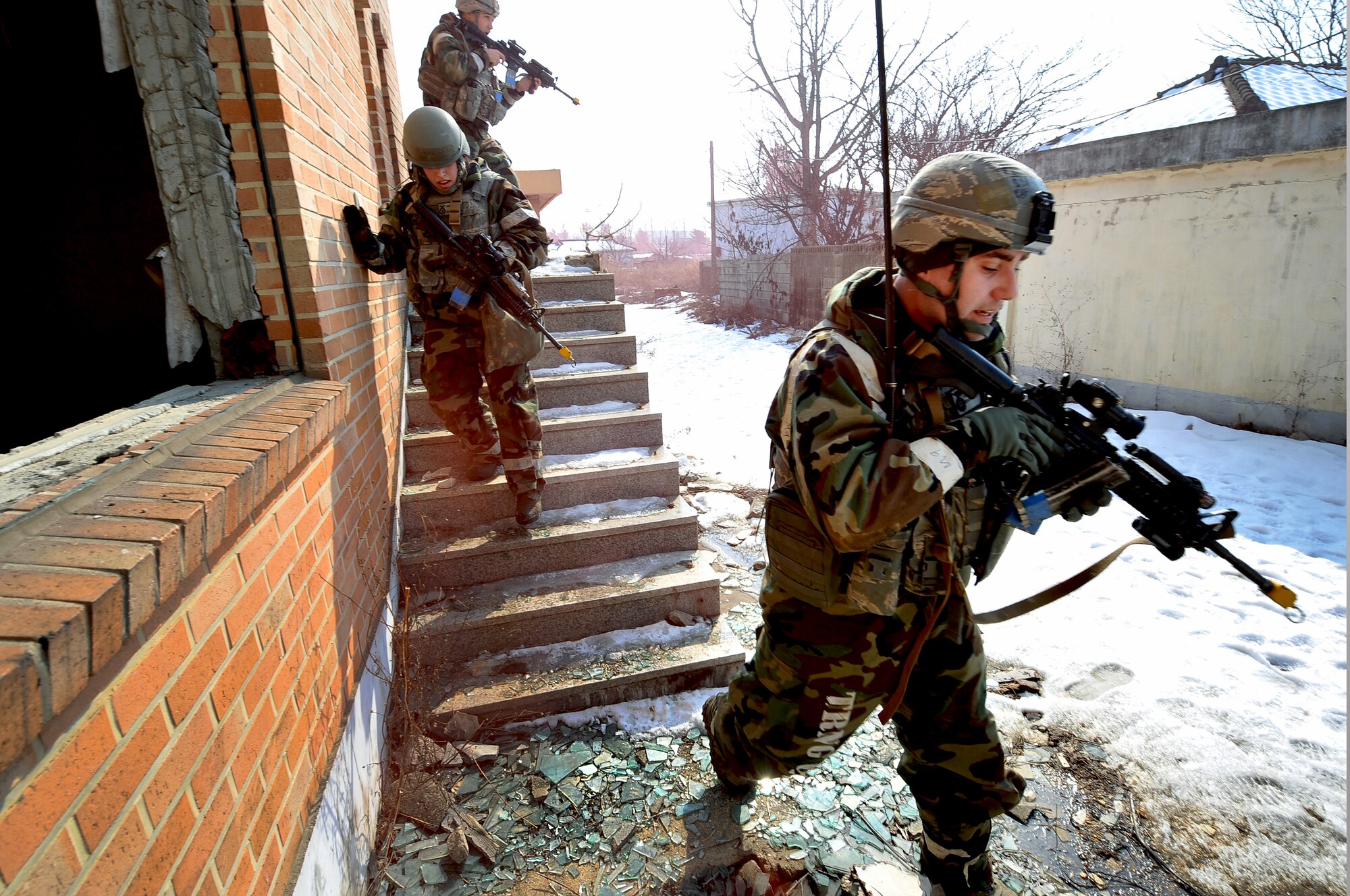 Airmen from the 51st Security Forces Squadron clear a village of mock enemy threats during a counter surveillance scenario for an operation readiness exercise, Beverly Bulldog 13-02 at Osan Air Base, Republic of Korea, Feb. 12, 2013. These exercises tests Osan Airmen’s abilities during a heightened state of readiness while providing combat ready forces for close air support, air strike control, counter air, interdiction, theater airlift, and communications in the defense of the Republic of Korea. (U.S. Air Force photo/Staff Sgt. Sara Csurilla)