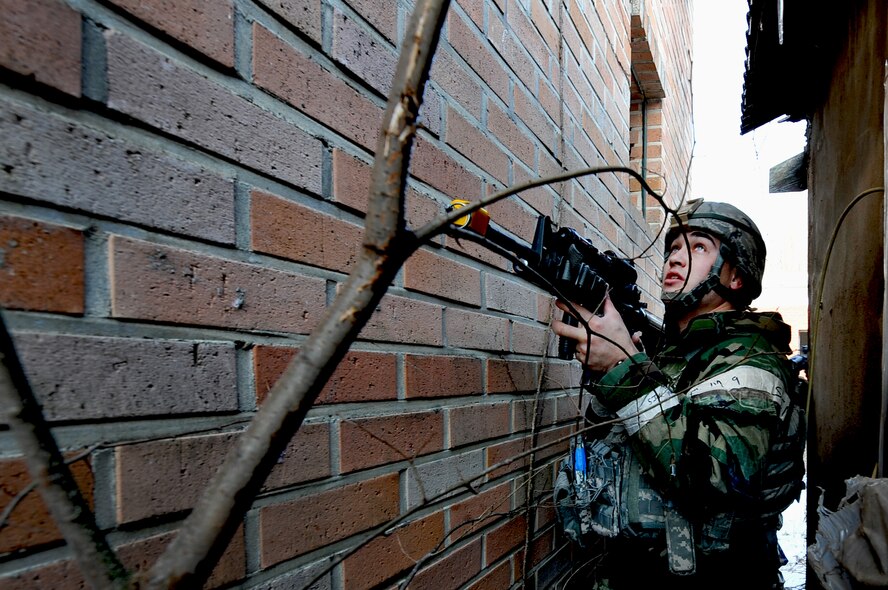 Senior Airman Christopher Hahn, 51st Security Forces member, checks his surroundings for enemy threats during a counter surveillance scenario for an operation readiness exercise, Beverly Bulldog 13-02 at Osan Air Base, Republic of Korea, Feb. 12, 2013. Counter surveillance scenarios are conducted to help train security forces Airmen to deny opposing forces entry to the base. (U.S. Air Force photo/Staff Sgt. Sara Csurilla)