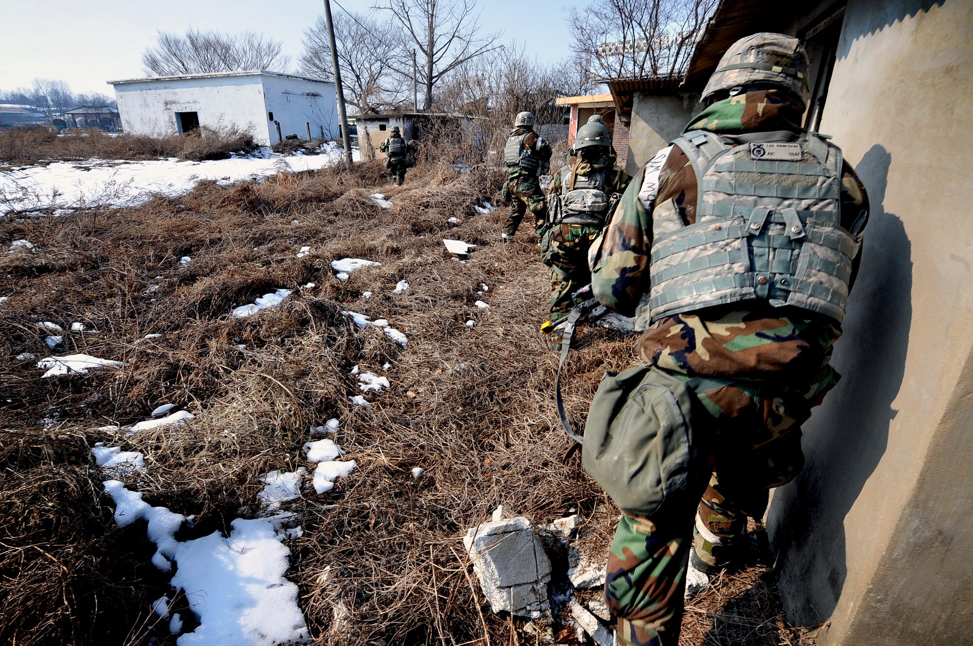 Airmen from the 51st Security Forces Squadron clear a village of mock enemy threats during a counter surveillance scenario for operation readiness exercise Beverly Bulldog 13-02 at Osan Air Base, Republic of Korea, Feb. 12, 2013. These exercises tests Osan Airmen’s abilities during a heightened state of readiness while providing combat ready forces for close air support, air strike control, counter air, interdiction, theater airlift, and communications in the defense of the Republic of Korea. (U.S. Air Force photo/Staff Sgt. Sara Csurilla)