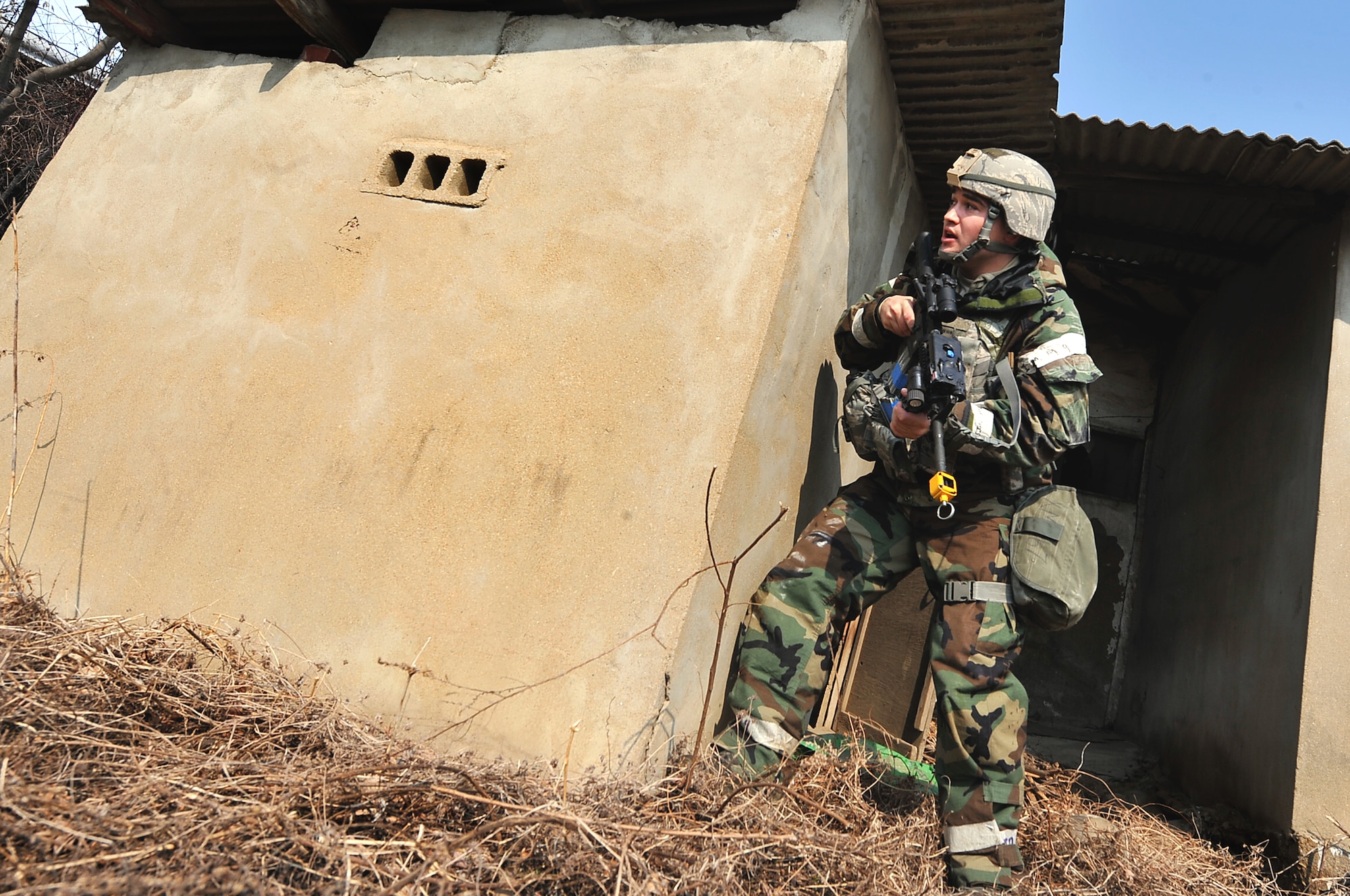 Senior Airman Christopher Hahn, 51st Security Forces Squadron defender, heads toward fellow defender after clearing a building of possible enemy threats during a counter surveillance scenario for operation readiness exercise Beverly Bulldog 13-02 at Osan Air Base, Republic of Korea, Feb. 12, 2013. Counter surveillance scenarios are conducted to help train security forces Airmen to deny opposing forces entry to the base. (U.S. Air Force photo/Staff Sgt. Sara Csurilla)