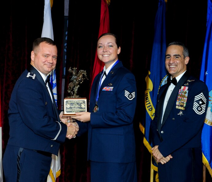 U.S. Air Force Staff Sgt. Tanya Moulding, 18th Component Maintenance Squadron, receives an award from Col. Brian McDaniel, 18th Wing vice commander, during the annual awards ceremony at the Rocker NCO Club on Kadena Air Base, Japan, Feb. 9, 2013. Moulding was recognized as the 18th Wing Airman of the Year for 2012. (U.S. Air Force photo/Airman 1st Class Justin Veazie)