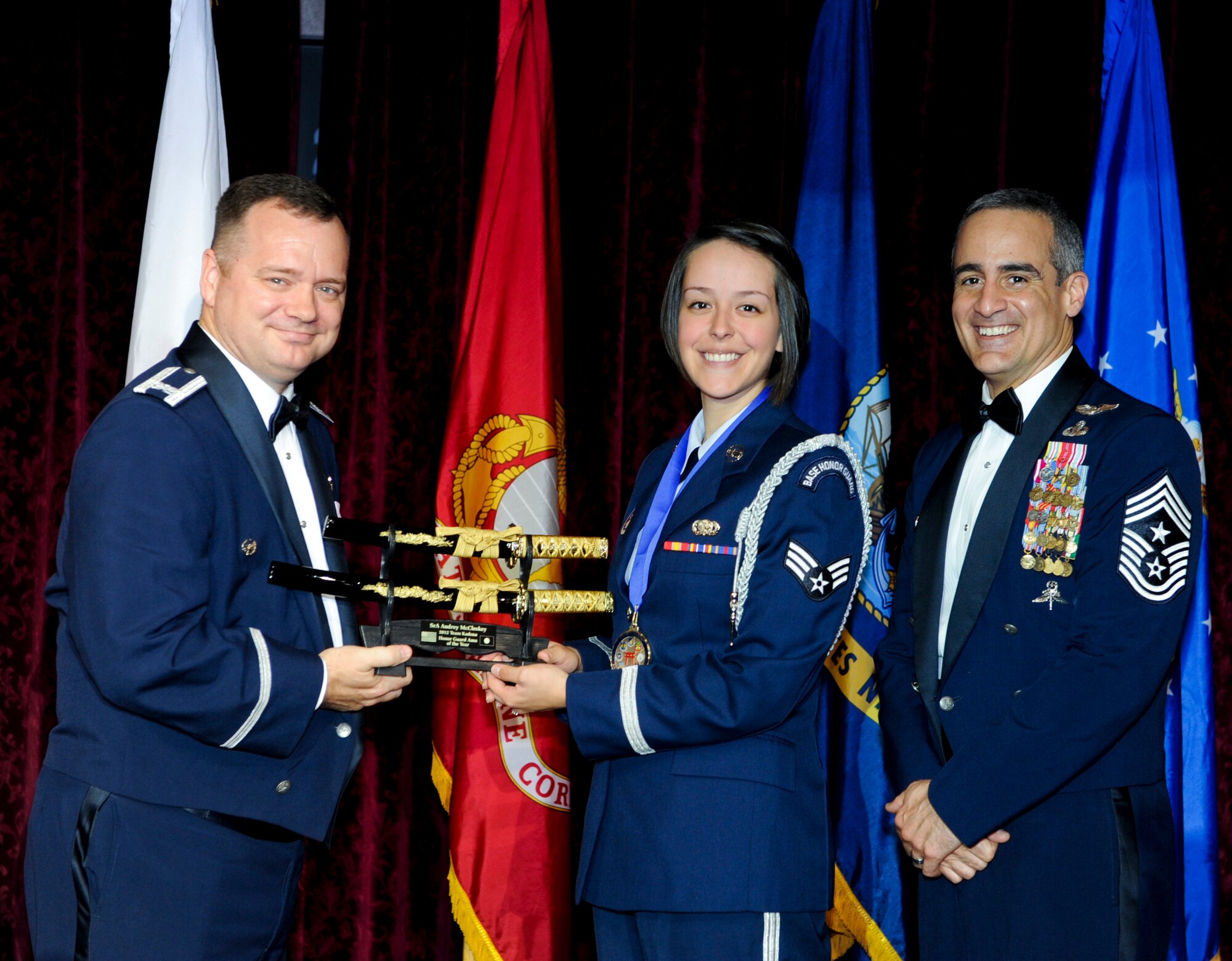 U.S. Air Force Senior Airman Audrey McCleskey, 18th Logistics Readiness Squadron, receives an award from Col. Brian McDaniel, 18th Wing vice commander, during the annual awards ceremony at the Rocker NCO Club on Kadena Air Base, Japan, Feb. 9, 2013. McCleskey was recognized as the Kadena Honor Guard Airman of the Year for 2012. (U.S. Air Force photo/Airman 1st Class Justin Veazie)