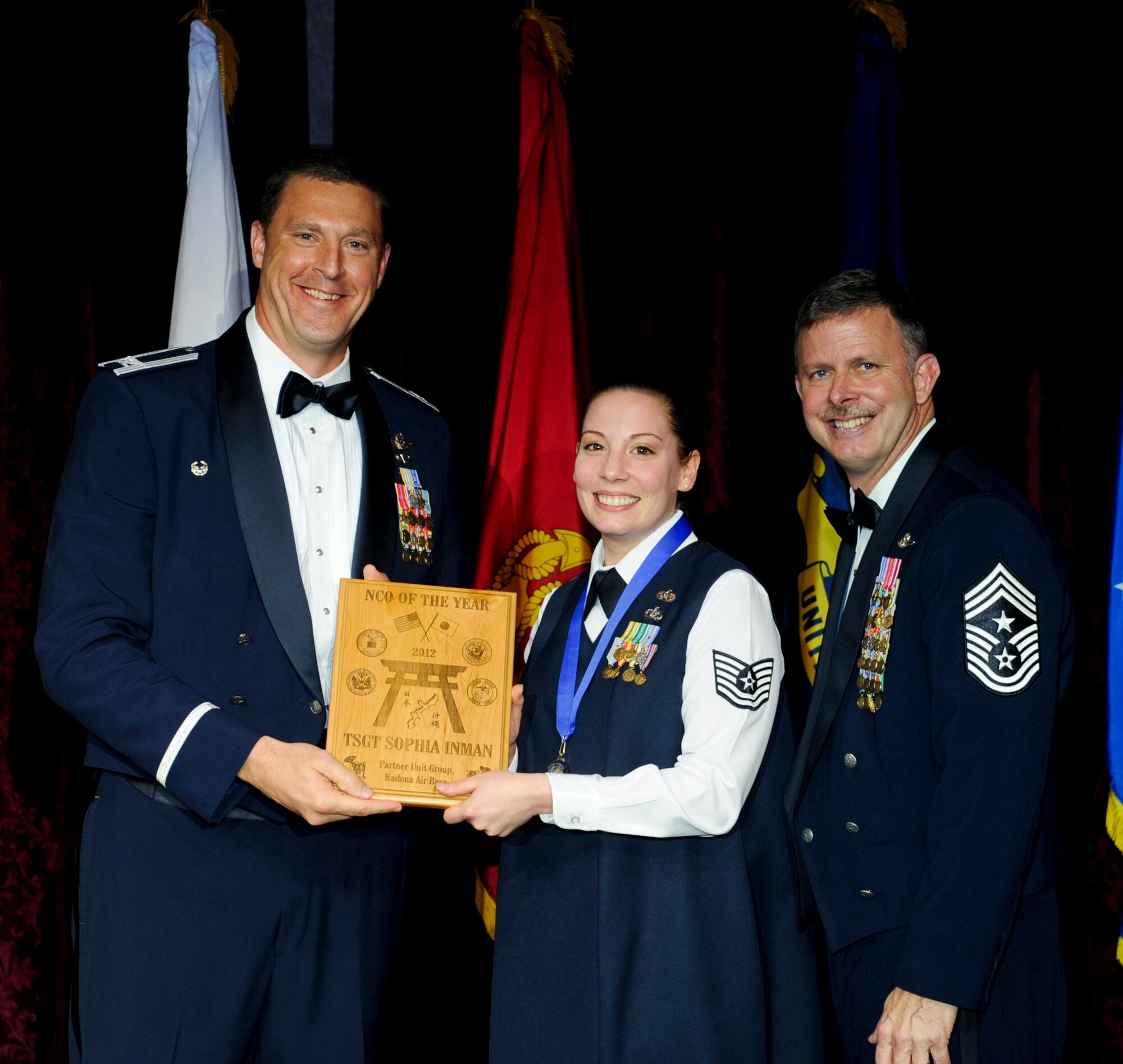 U.S. Air Force Tech. Sgt. Sophia Inman, 353rd Special Operations Group, receives an award from Col. Brad Sullivan, 353rd SOG commander, during the annual awards ceremony at the Rocker NCO Club on Kadena Air Base, Japan, Feb. 9, 2013. Inman was recognized as the Partner Unit Group NCO of the Year for 2012. (U.S. Air Force photo/Airman 1st Class Justin Veazie)