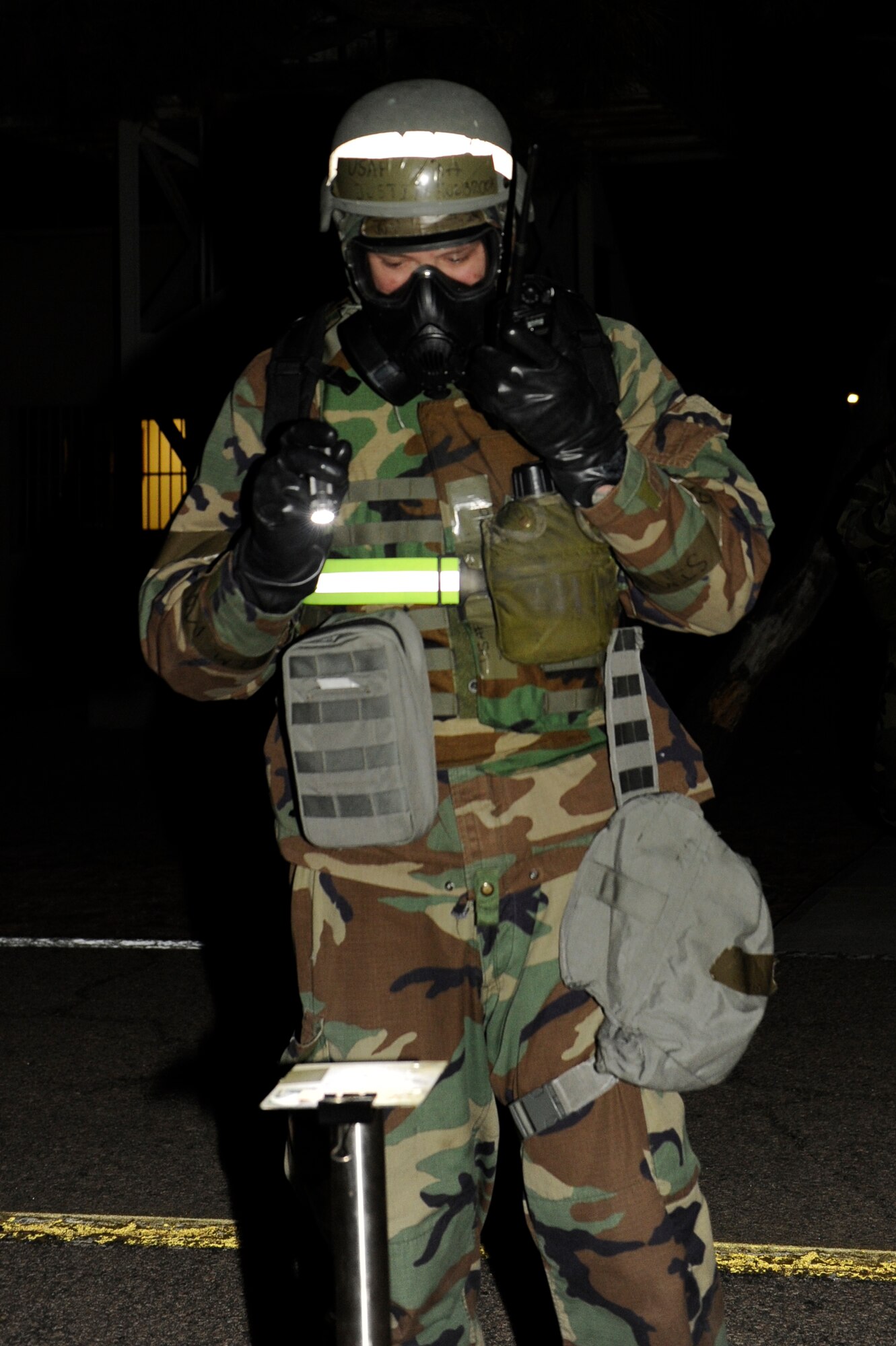 KUNSAN AIR BASE, Republic of Korea -- Senior Airman Justin Holbrook, 8th Operations Support Squadron, checks M-8 paper while performing post-attack reconnaissance checks during exercise Beverly Bulldog 13-2 at Kunsan Air Base, Republic of Korea, Feb. 13, 2013. PAR teams check for casualties, unexploded ordnance, contamination from chemical, biological, radiological, nuclear or explosive weapons, and damage to structures and equipment. (U.S. Air Force photo by Senior Airman Marcus Morris/Released)