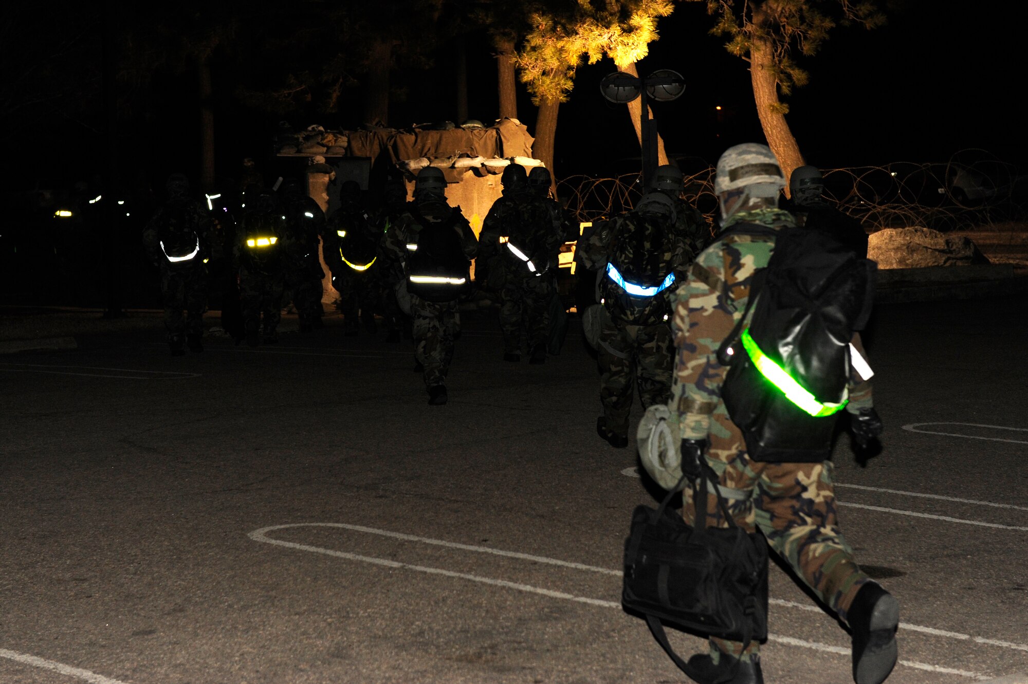 KUNSAN AIR BASE, Republic of Korea --Members of the 8th Fighter Wing staff “bug-out” after a simulated fire in the building during the early morning hours of exercise Beverly Bulldog 13-2 at Kunsan Air Base, Republic of Korea, Feb. 13, 2013. In addition to the Mission Oriented Protective Posture gear, the scenario added a level of stress to test the members’ ability to operate from an alternate site. (U.S. Air Force photo by Senior Airman Marcus Morris/Released)
