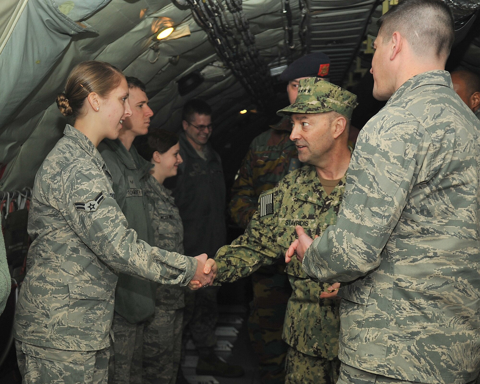 U.S. Navy Admiral James Stavridis, U.S. European Command commander and NATO’s Supreme Allied Commander Europe, coins U.S. Air Force Airman 1st Class Bethany Roczen, 95th Reconnaissance Squadron operations intelligence analyst from Barneveld, N.Y., Feb. 12, 2013, at RAF Mildenhall, England. The admiral visited RAF Mildenhall and RAF Lakenheath on a site visit touring U.S. and NATO assets assigned in the U.K. (U.S. Air Force photo by Senior Airman Jerilyn Quintanilla/Released)   