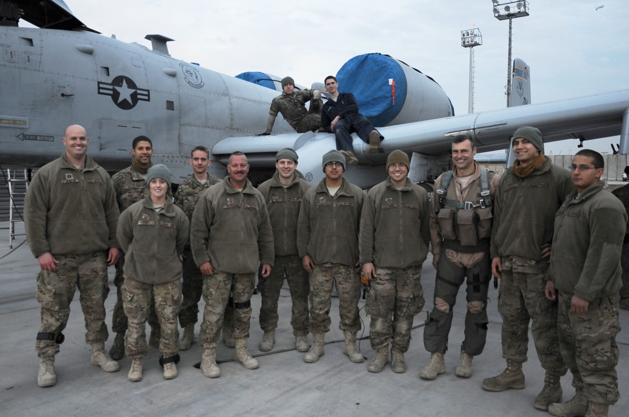 Members of the 455th Expeditionary Aircraft Maintenance Squadron join Brig. Gen. Joseph T. Guastella Jr. (third from left), 455th Air Expeditionary Wing commander, on the flightline at Bagram Airfield, Afghanistan, Feb. 12, 2013. Guastella had just returned from logging the 10,000th combat flight hour for the 354th Expeditionary Fighter Squadron since the unit?s arrival. The 354th EFS, flying the A-10 Thunderbolt II, has been deployed from Davis-Monthan Air Force Base, Ariz., since October 2012. (U.S. Air Force photo/Staff Sgt. David Dobrydney)
