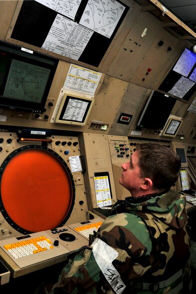Master Sgt. Robert Coad, 51st Operations Support Squadron radar approach controller, monitors his radar while in Mission Oriented Protective Posture gear during operational readiness exercise Beverly Bulldog 13-02 at Osan Air Base, Republic of Korea, Feb. 12, 2013. While Airmen in the air control tower visually control a five-mile radius, RAPCON Airmen monitor 50 miles out to coordinate with pilots and the tower. (U.S. Air Force photo/Airman 1st Class Alexis Siekert)