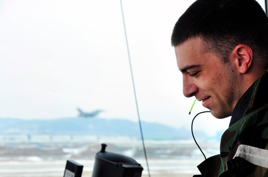 Senior Airman Matthew Burt, 51st Operations Support Squadron air traffic controller, communicates with pilots as they take off on exercise combat sorties as part of operational readiness exercise Beverly Bulldog 13-02 at Osan Air Base, Republic of Korea, Feb. 12, 2013. During exercises, ATCs wear their Mission Oriented Protective Posture gear while still coordinating the mission. (U.S. Air Force photo/Airman 1st Class Alexis Siekert)