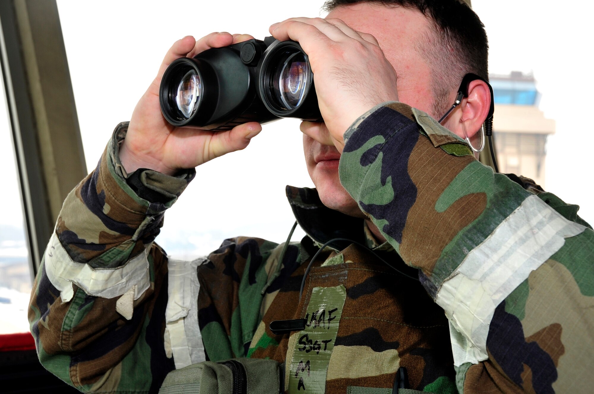 Staff Sgt. Matthew Miller, 51st Operations Support Squadron air traffic control journeyman, scans the flightline while communicating with pilots departing on exercise combat sorties as part of operational readiness exercise Beverly Bulldog 13-02 at Osan Air Base, Republic of Korea, Feb. 12, 2013. The team in the tower work as the eyes of the flightline to coordinate positioning with pilots. (U.S. Air Force photo/Airman 1st Class Alexis Siekert)
