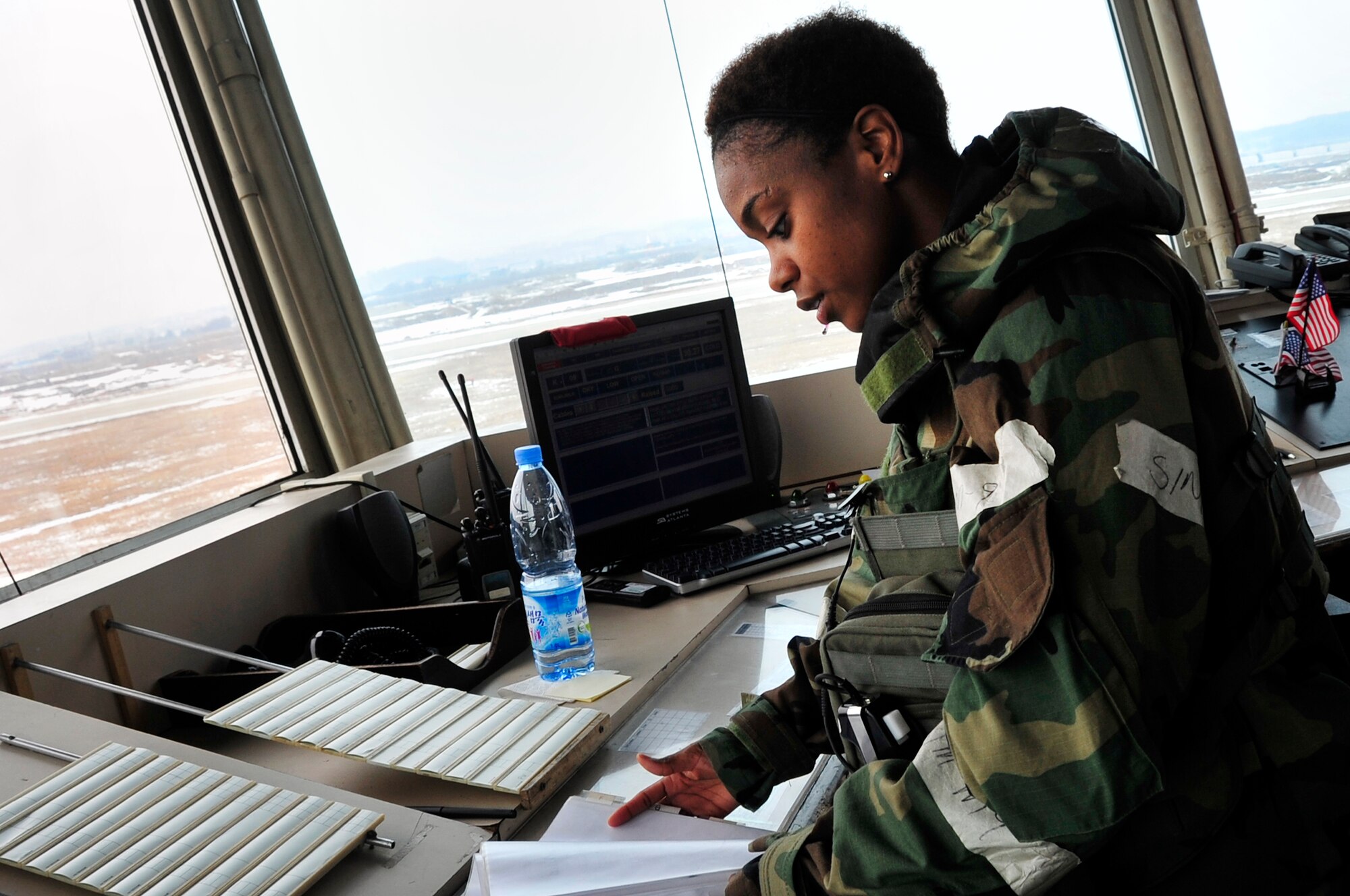 Staff Sgt. Jillion Clark, 51st Operations Support Squadron air traffic control journeyman, checks the incoming flight schedule while working at an accelerated tempo to accommodate the operational readiness exercise, Beverly Bulldog 13-02, at Osan Air Base, Republic of Korea, Feb. 12, 2013. Air traffic controllers direct the movement of aircraft into and out of military airfields all over the world, track aircraft by radar and give voice instructions by radio. (U.S. Air Force photo/Airman 1st Class Alexis Siekert)