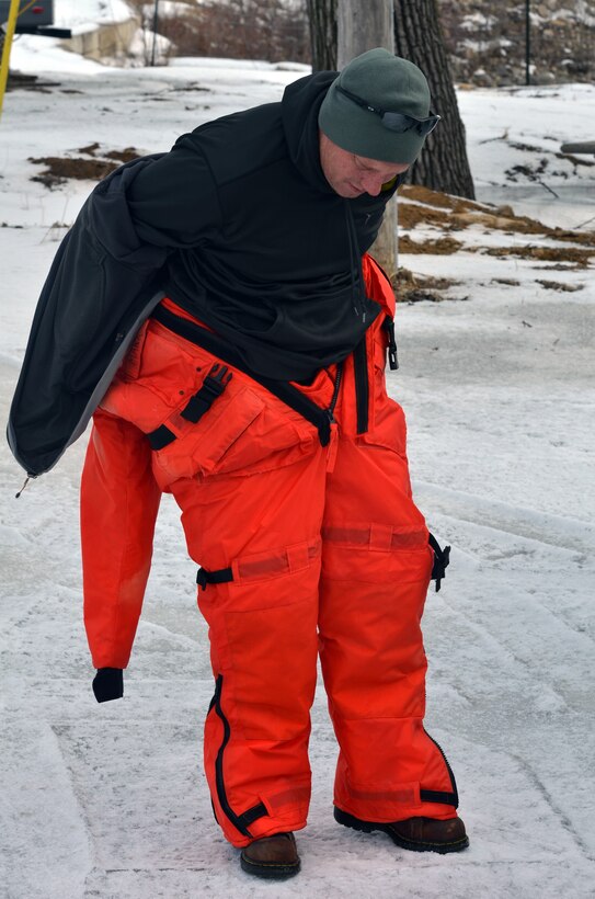 WABASHA, Minn. – Al VanGuilder, St. Paul District survey technician, dawns cold weather flotation clothing prior to going on Lake Pepin, near Wabasha, Minn., Feb. 13, during the first Mississippi River ice surveys of the year. The district conducts the annual ice surveys to help the navigation industry determine when it is safe to break through the ice. Lake Pepin, located on the Mississippi River between Red Wing and Wabasha, Minn., is used as the benchmark because the ice melts slower in this area due to the lake width and the slower current.